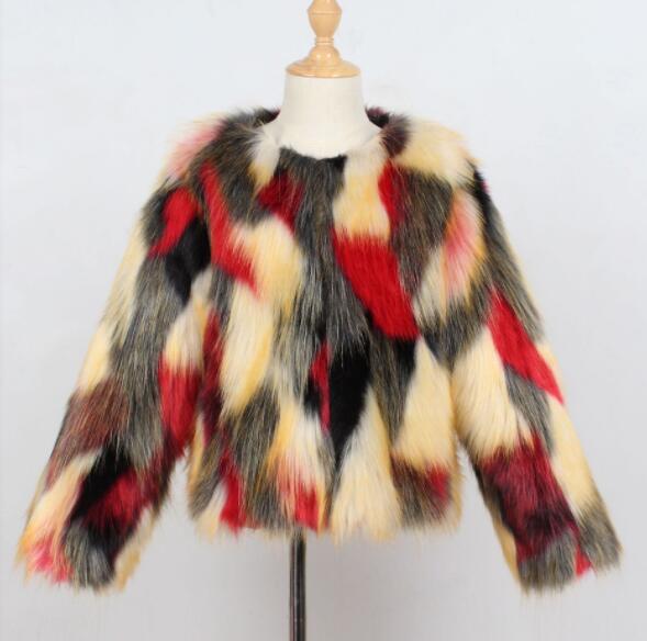 Colorful faux fur children's jacket featuring a bold patchwork design in red, black, yellow, and cream.
