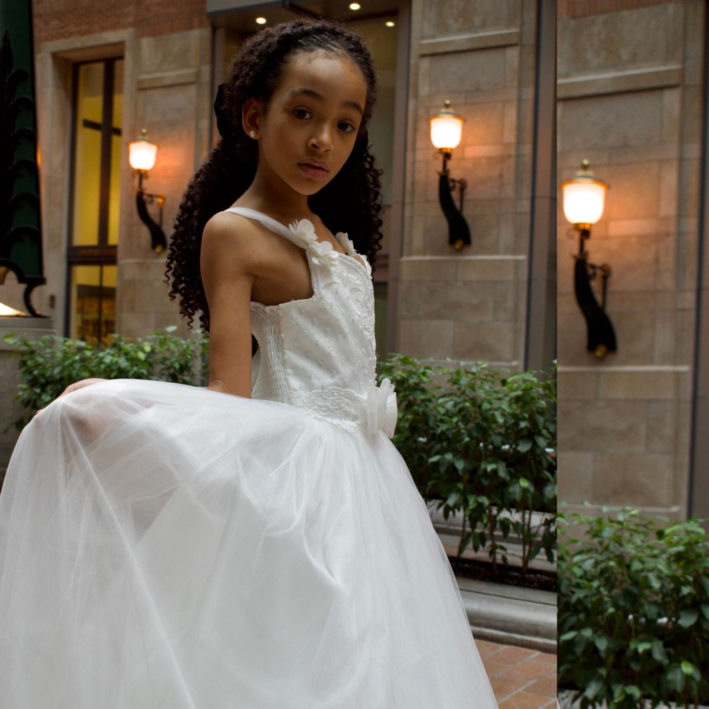 Bianca Princess Girls Formal Dress features a white, sleeveless design with a tulle skirt and floral embellishments.