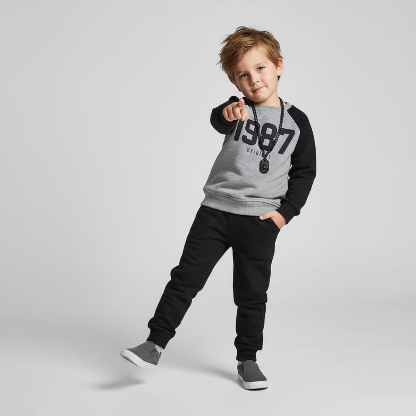 Boys joggers set featuring a gray and black long-sleeve top with "1987" print and black joggers, styled with a necklace.