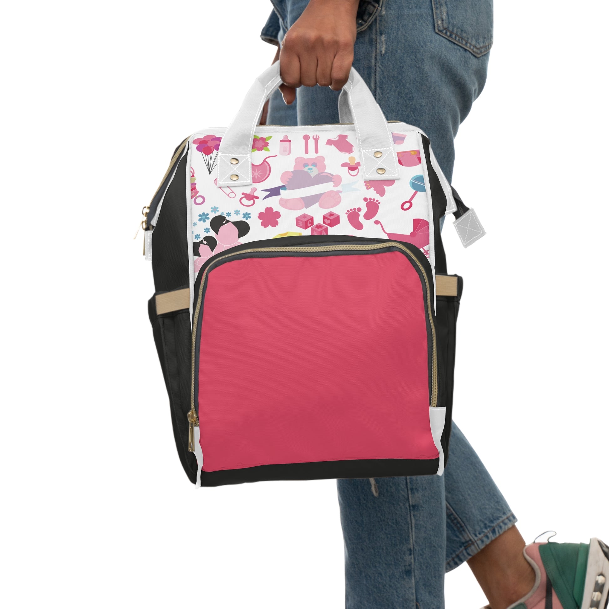 Pink Baby Pattern Diaper Backpack featuring a playful design with baby items, held by a person in casual attire.