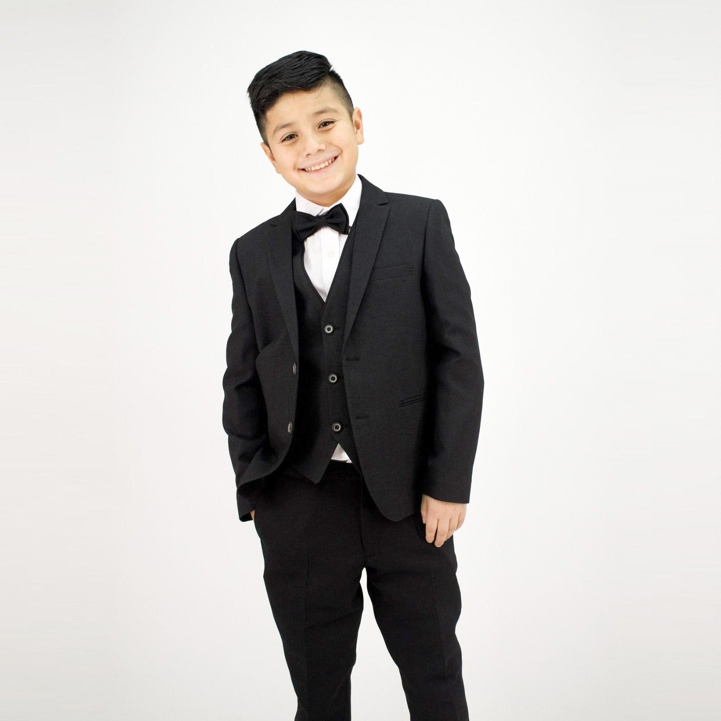 Captain Stylish Formal Boys Suit featuring a black tuxedo with a bow tie, worn by a smiling boy against a plain background.