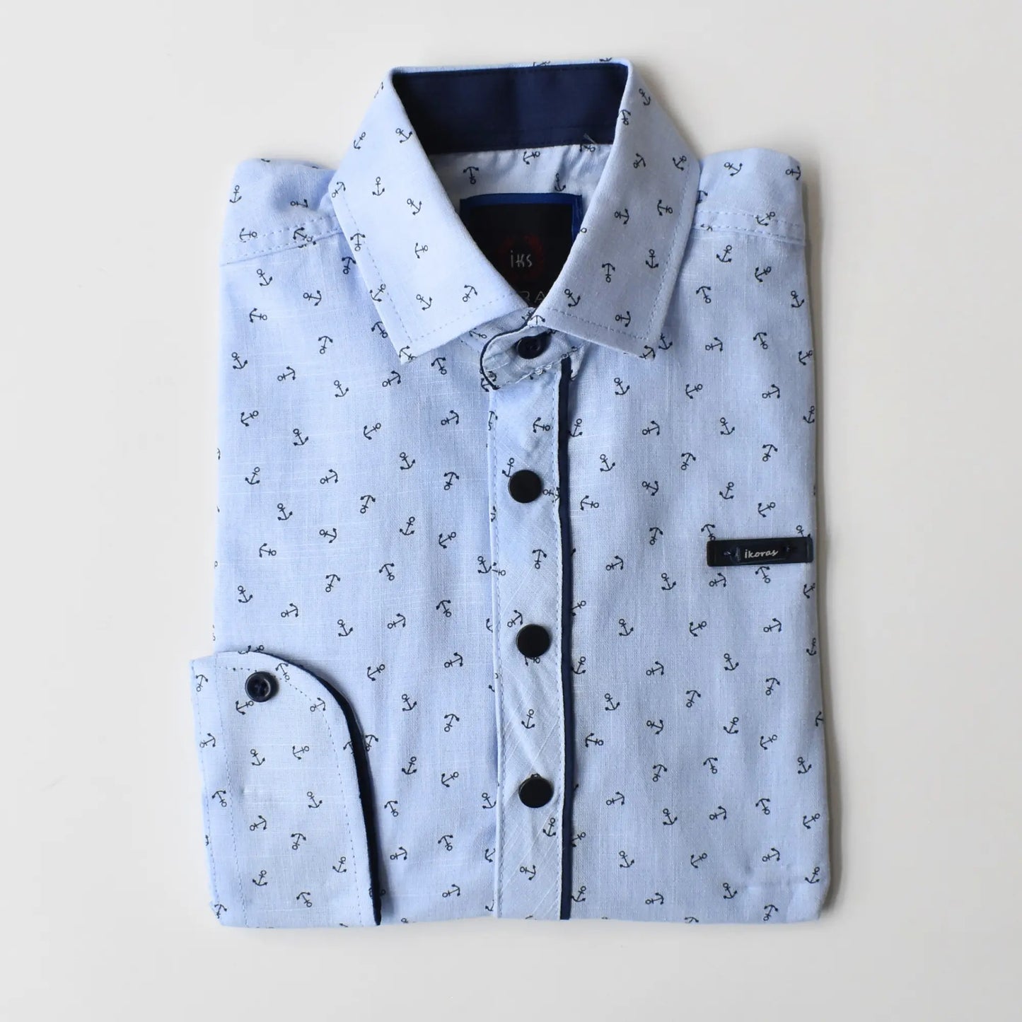 Folded Anchor Boys Cotton Shirt in light blue with anchor print, featuring a dark blue collar and button details.