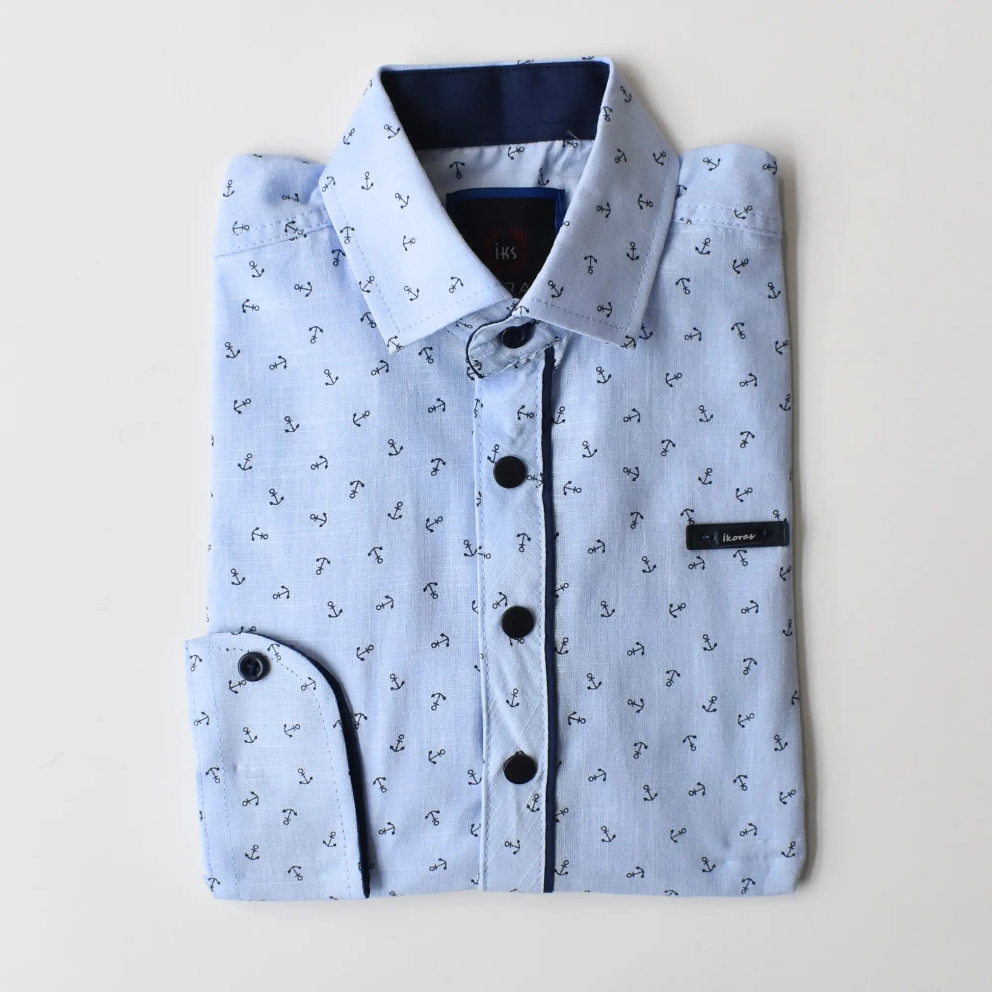 Folded Anchor Boys Cotton Shirt in light blue with anchor print, featuring a dark blue collar and button details.