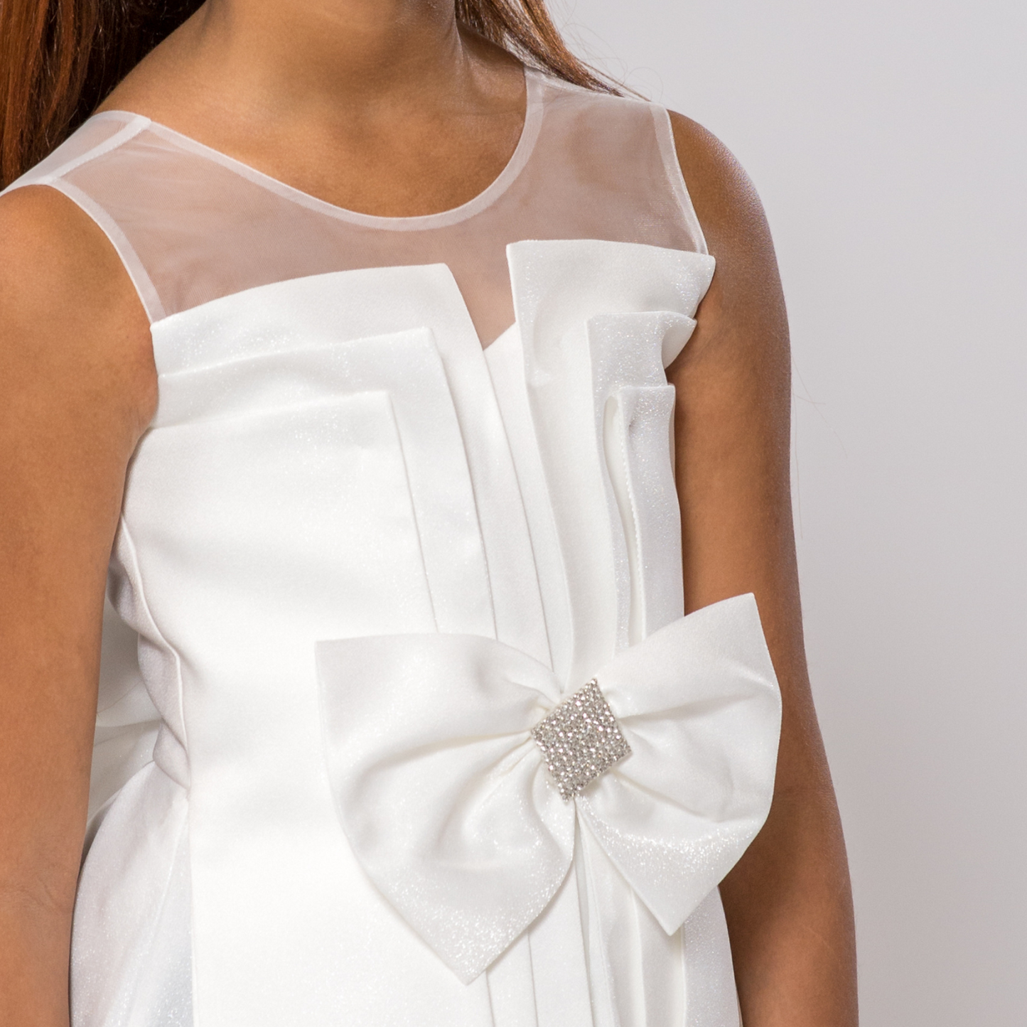 White Splendid Charm A-Line Dress featuring a sheer neckline and a large bow with a rhinestone accent.