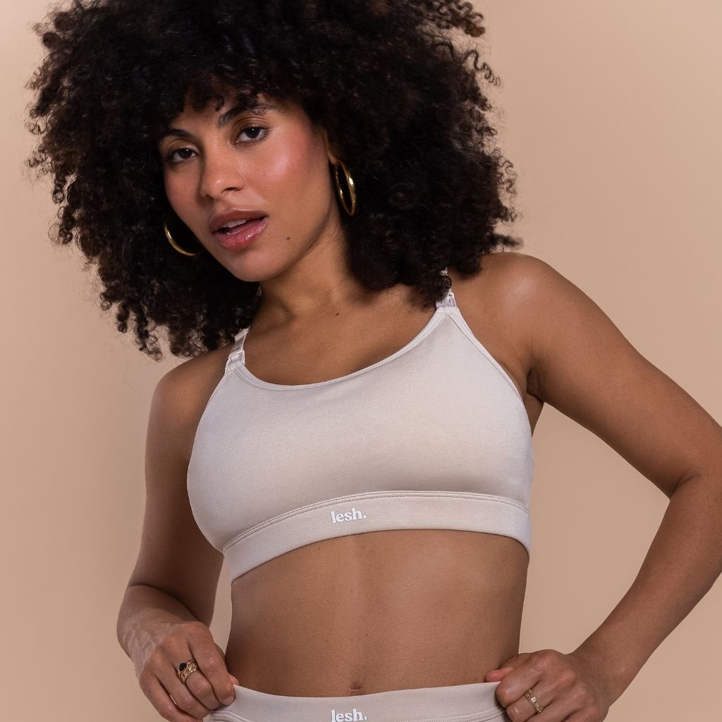 Lesh Freeflo 2.0 Leakproof Nursing Bra in beige, featuring adjustable straps and a comfortable fit, modeled by a woman.