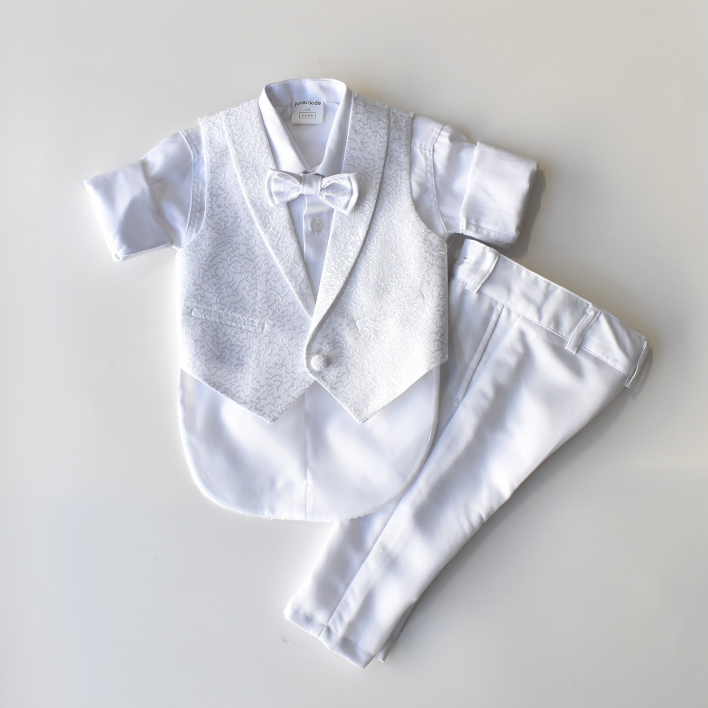 Archie's Penguin Tail Vest Set featuring a white short-sleeve shirt, patterned vest, bow tie, and matching pants.