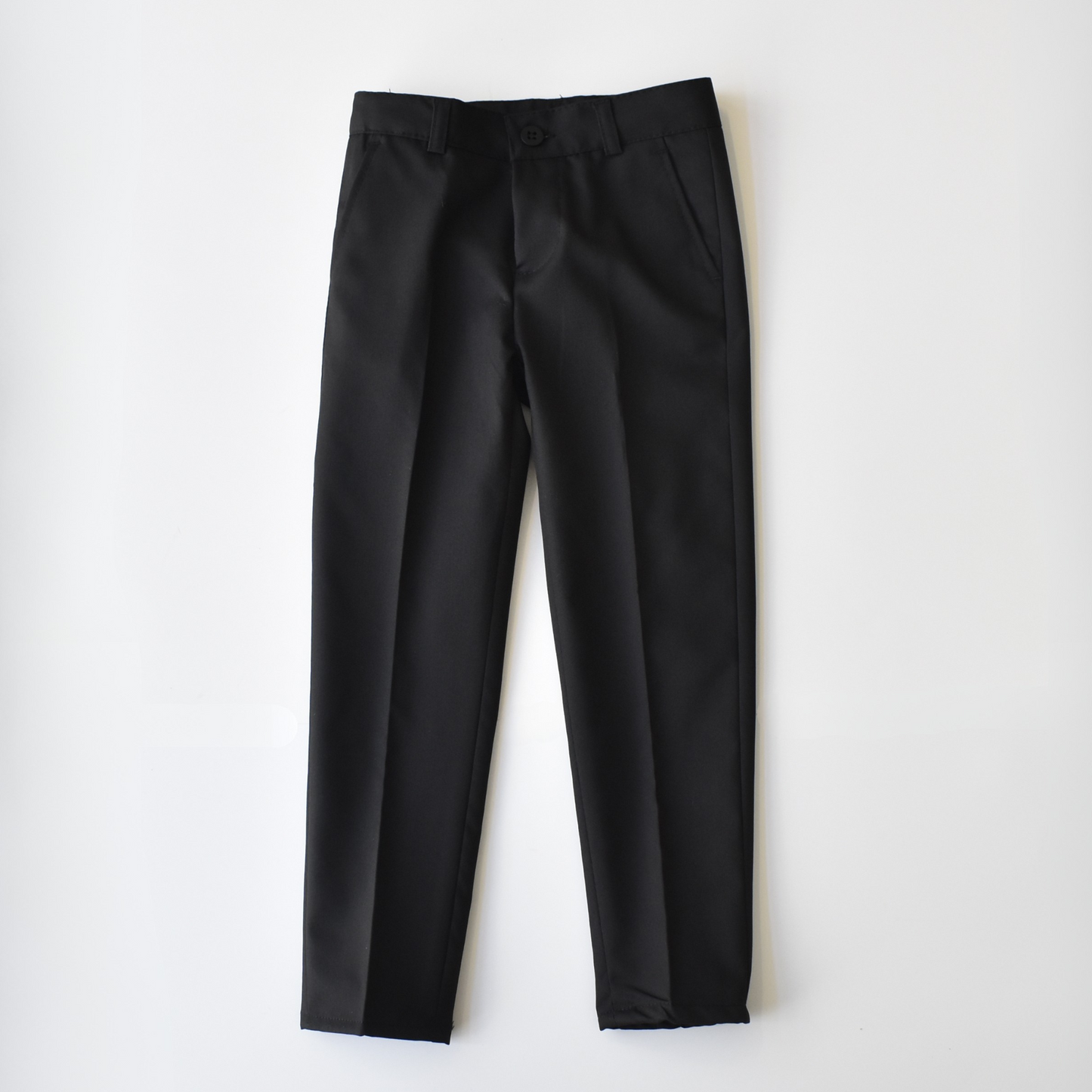 Black boys' suit pants from the Not Like Me collection, featuring a classic fit and sleek design.