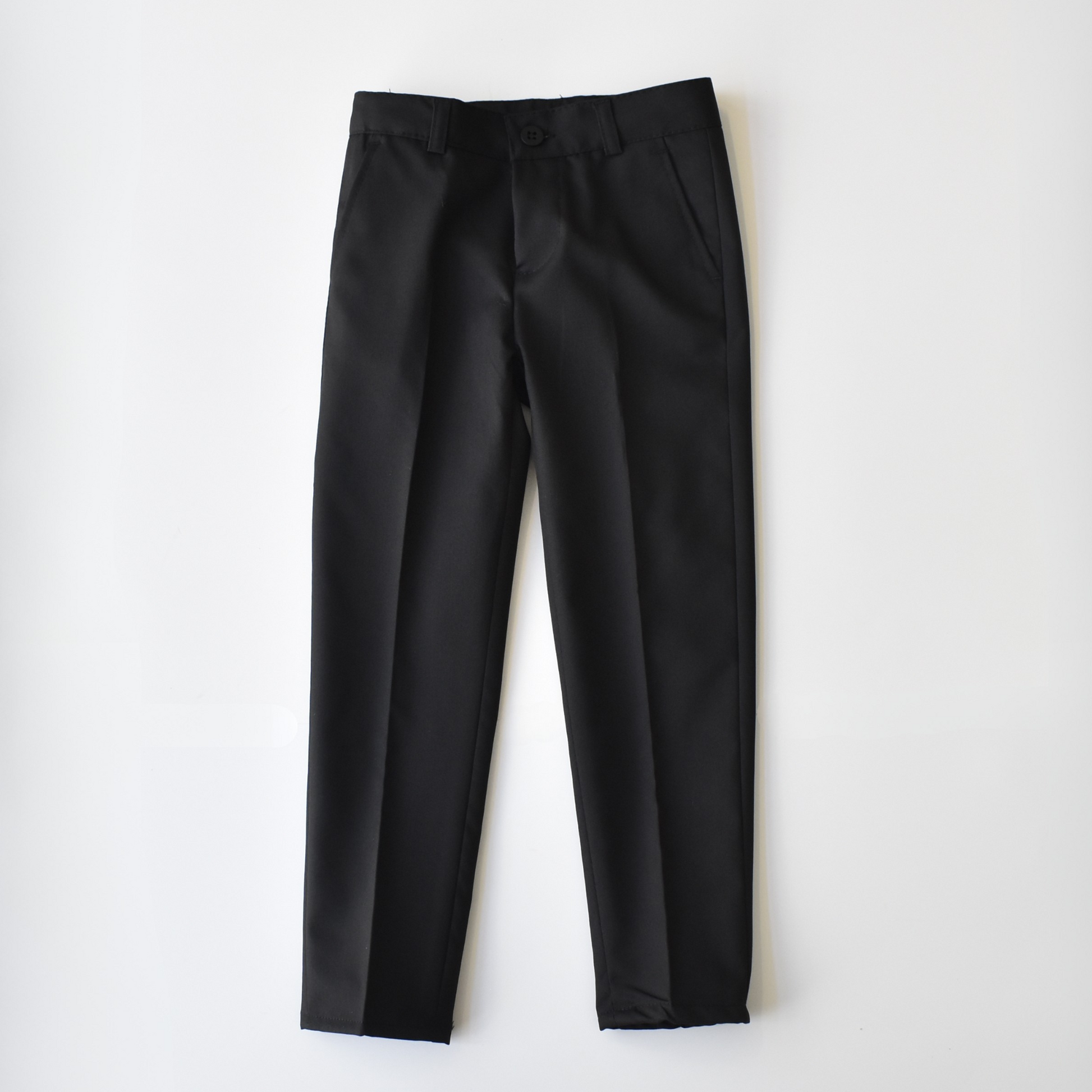 Black boys' suit pants from the Not Like Me collection, featuring a classic fit and sleek design.
