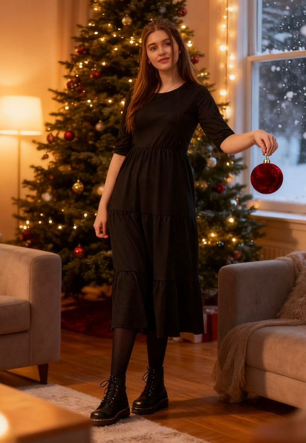The Midi Breastfeeding Dress - Beth Black Cotton features a tiered design, long sleeves, and a relaxed fit, styled with a fes