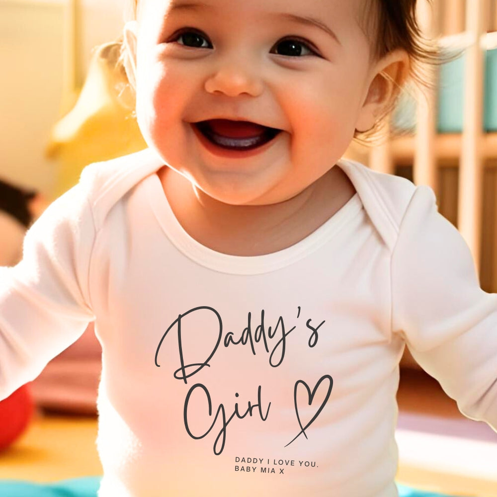 Personalised Daddy's Girl Baby Outfit featuring a smiling baby in a white vest with "Daddy's Girl" text.