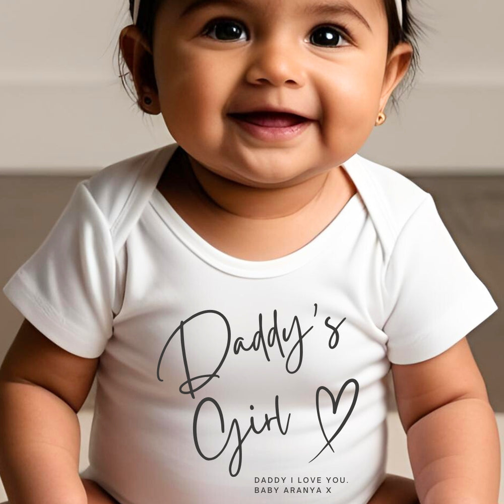 Personalised Daddy's Girl Baby Outfit featuring a white onesie with "Daddy's Girl" text and a smiling baby.
