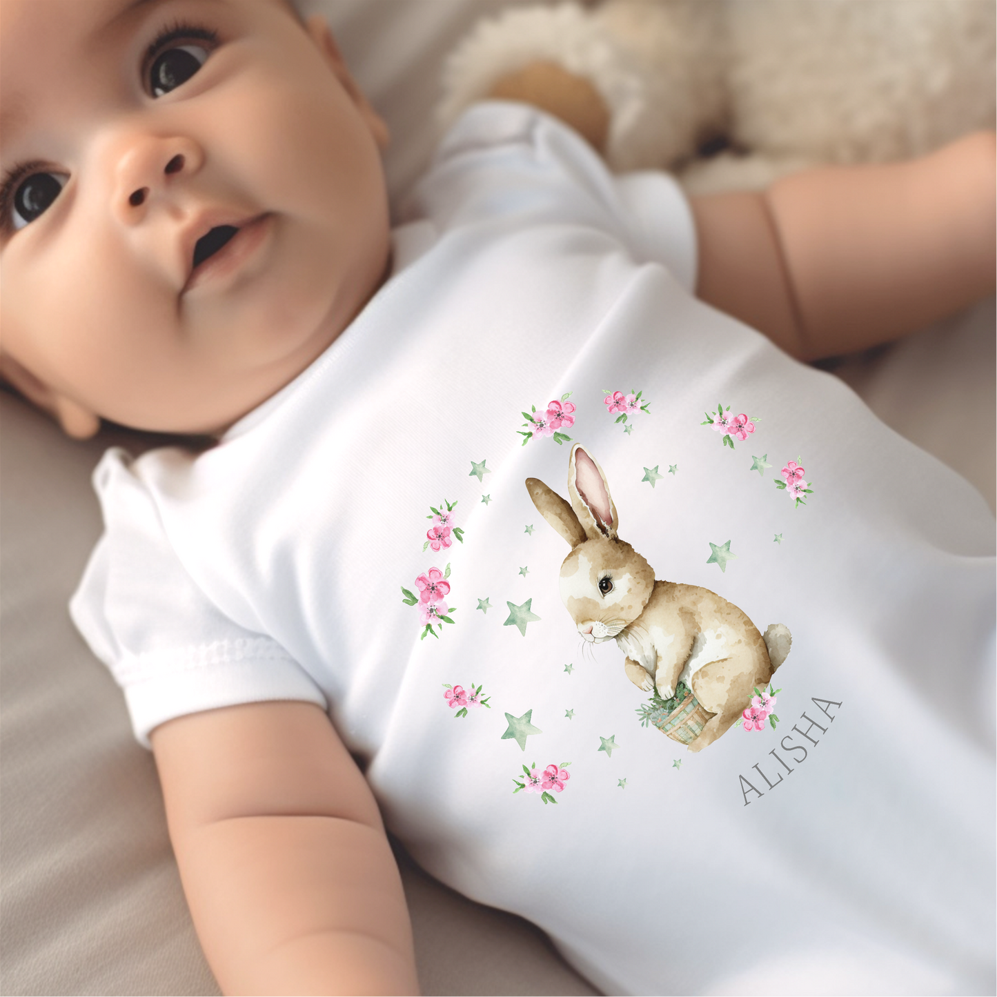 Personalised Girls Bunny Baby Outfit featuring a white baby grow with a cute bunny illustration and floral accents.
