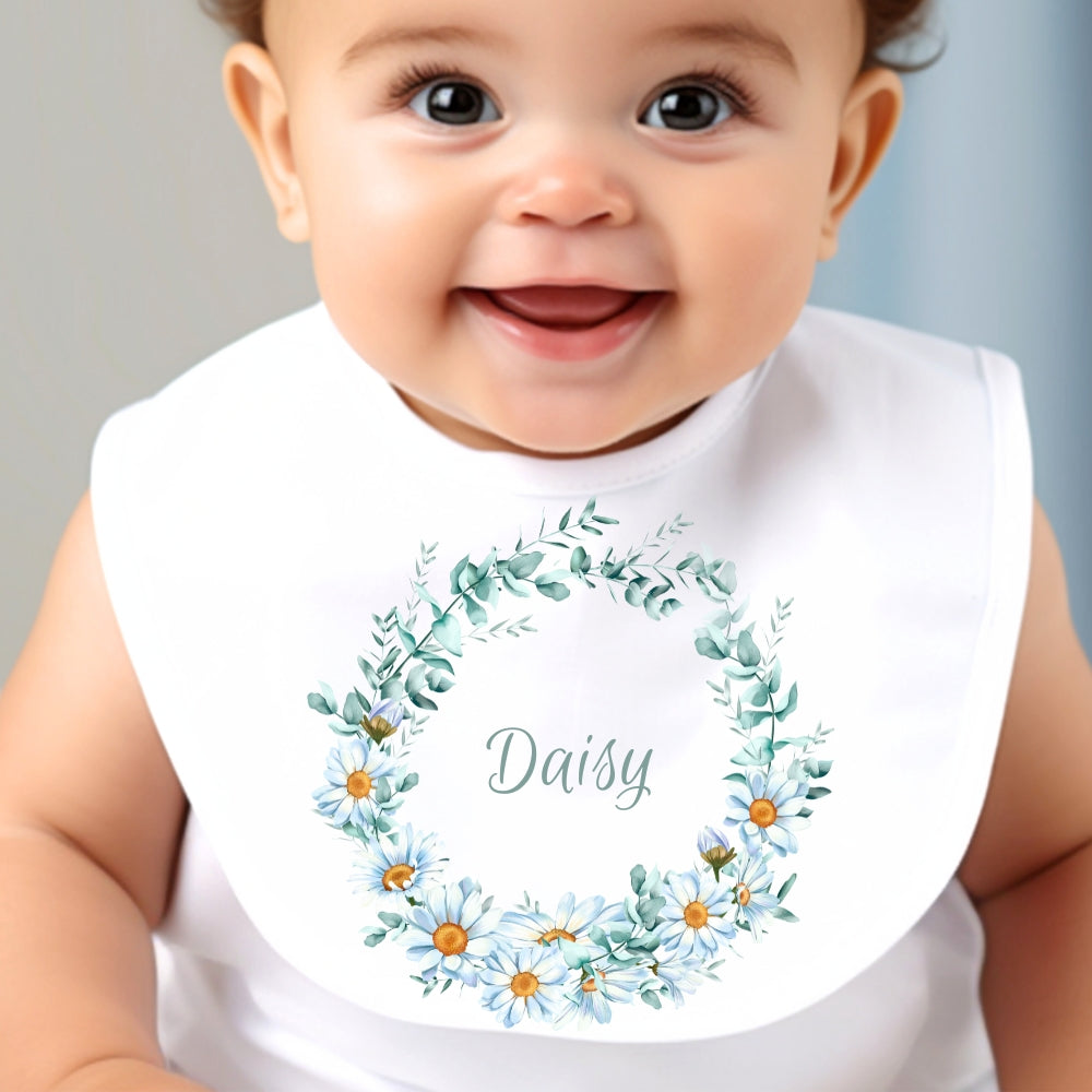 Personalised Daisy Flowers Baby Outfit featuring a smiling baby wearing a bib with a floral design and the name "Daisy."