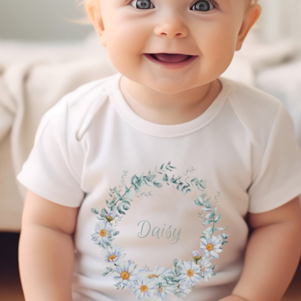 Personalised Daisy Flowers Baby Outfit featuring a white vest with a floral design and the name "Daisy."
