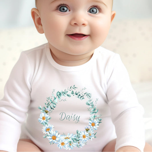 Personalised Daisy Flowers Baby Outfit featuring a white vest with a floral design and the name "Daisy."