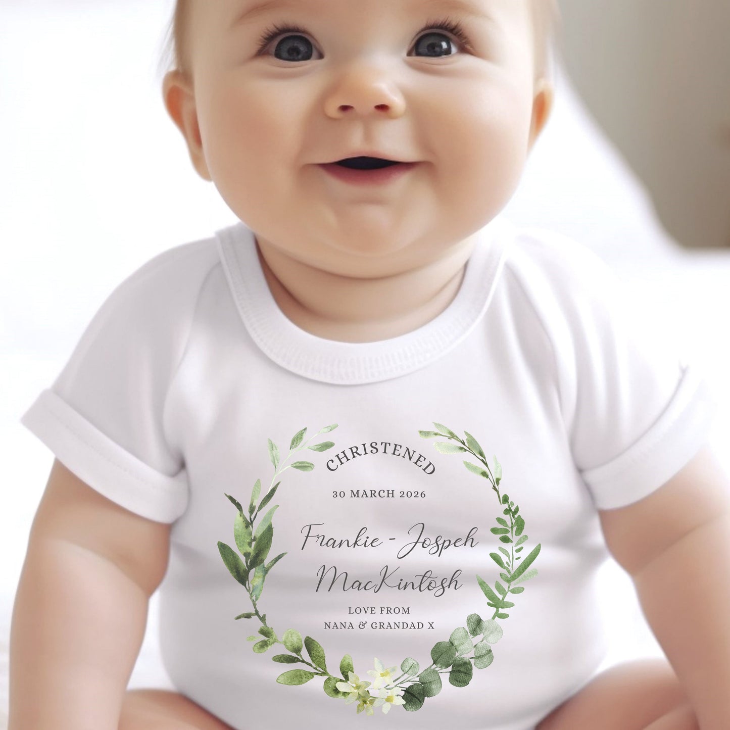 Personalised Christening Day Baby Outfit featuring a white vest with floral design and custom name details.