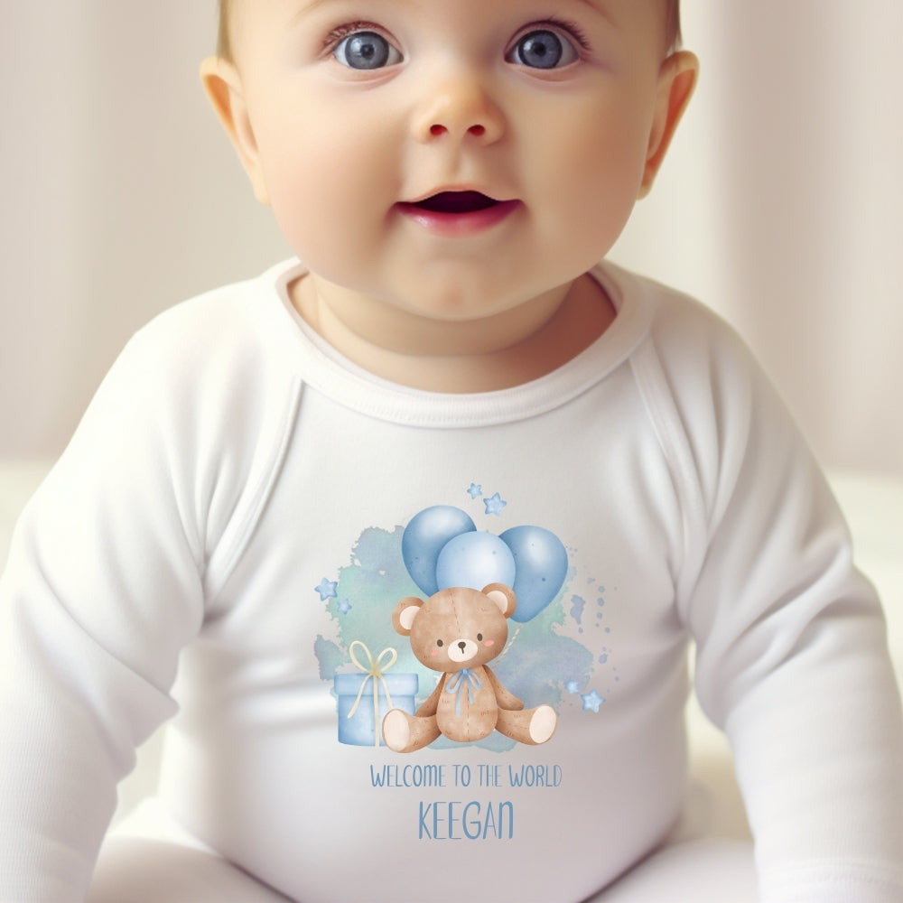 Personalised Baby Boy Outfit featuring a white vest with a teddy bear design and "Welcome to the World Keegan" text.