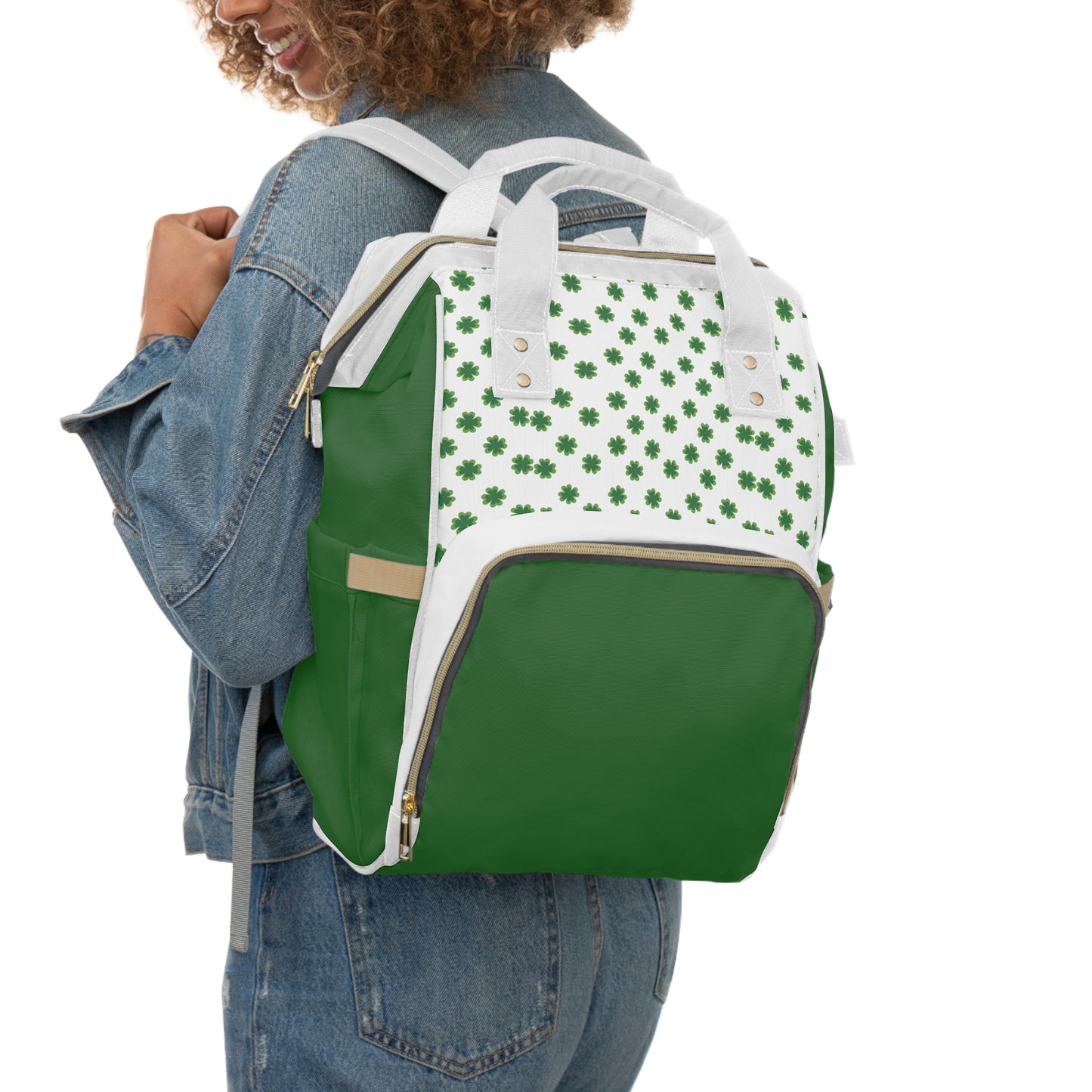Clover Diaper Backpack featuring a shamrock print, green and white design, worn on a person's back.