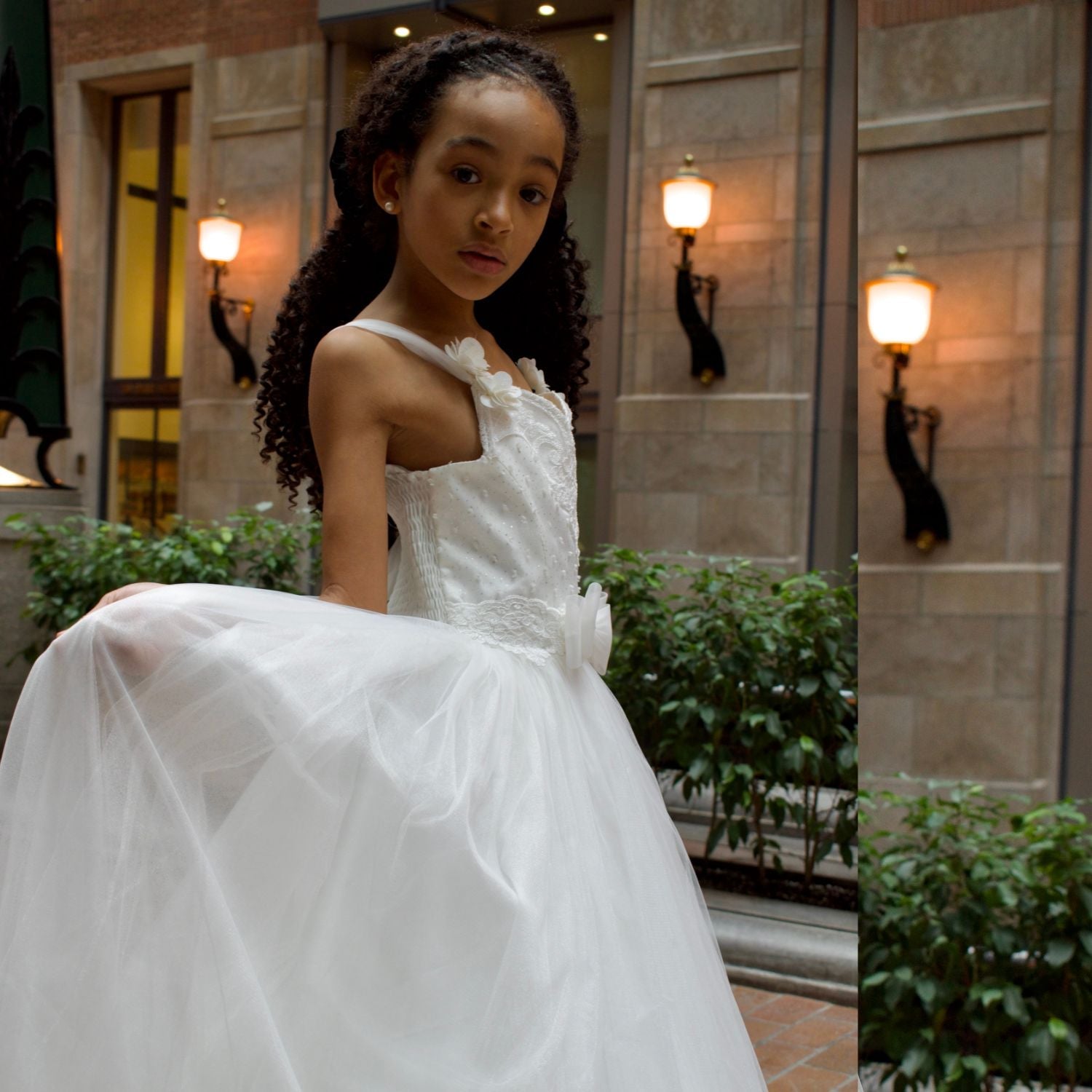 Bianca Princess Girls Formal Dress features a white, sleeveless design with a tulle skirt and floral embellishments.