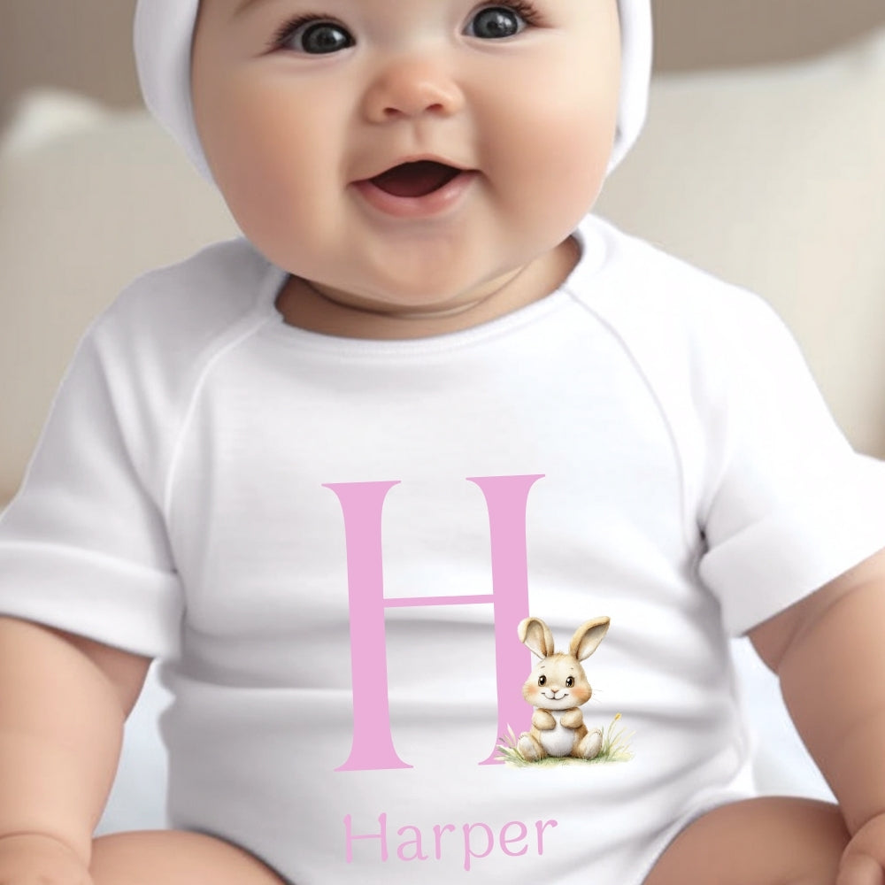 Personalised Pink Initial Bunny Baby Outfit featuring a white vest with a pink letter "H" and a cute bunny illustration.