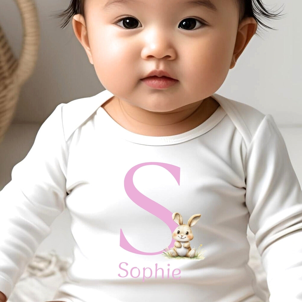 Personalised pink initial bunny baby outfit featuring a bib, vest, and baby grow with a cute bunny design.