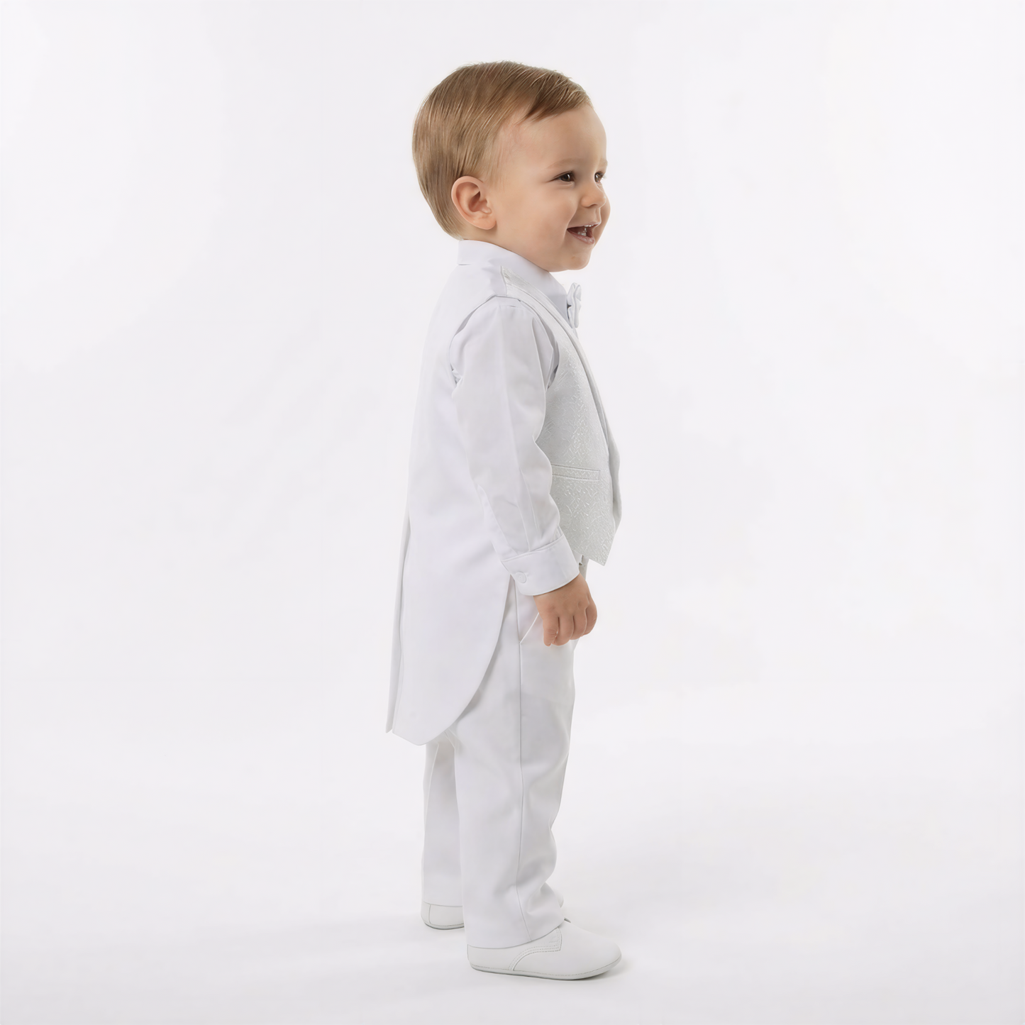 Archie's Penguin Tail Vest Set features a toddler in a white tuxedo with a tailcoat, bow tie, and matching vest.