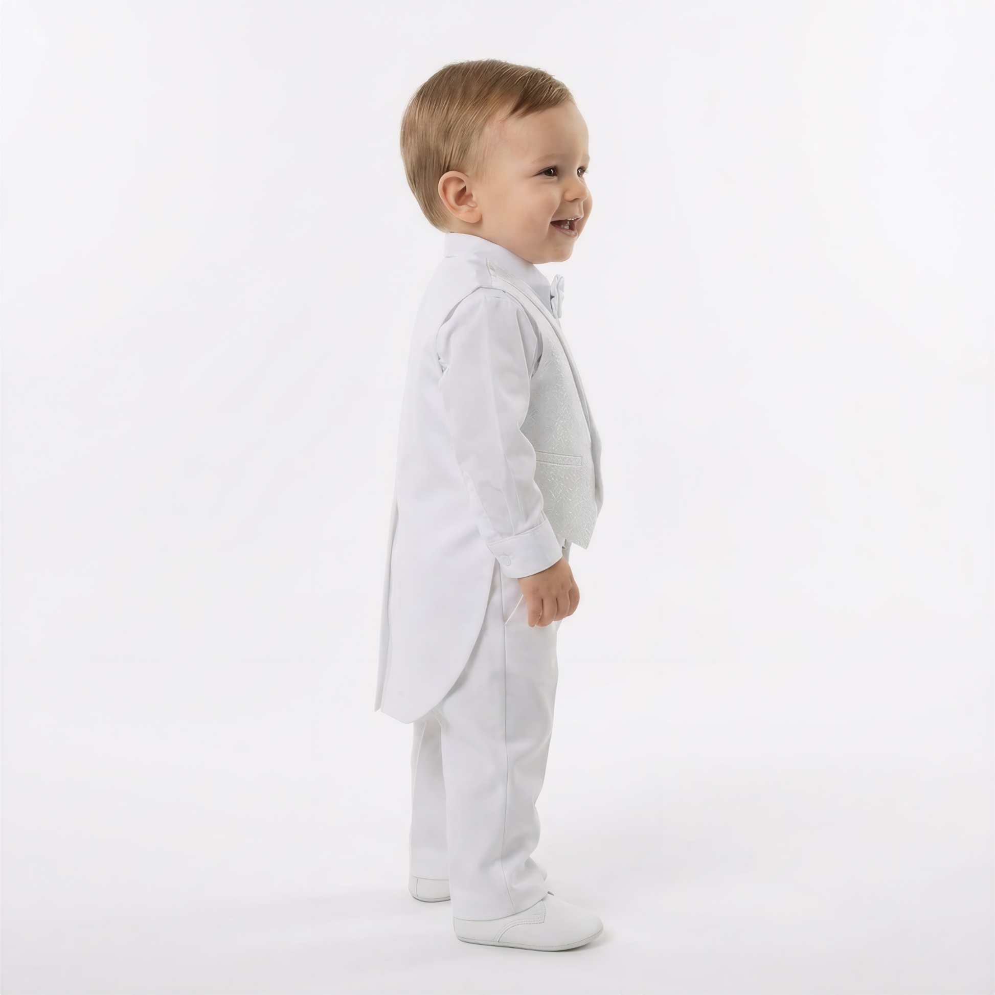 Archie's Penguin Tail Vest Set features a toddler in a white tuxedo with a tailcoat, bow tie, and matching vest.