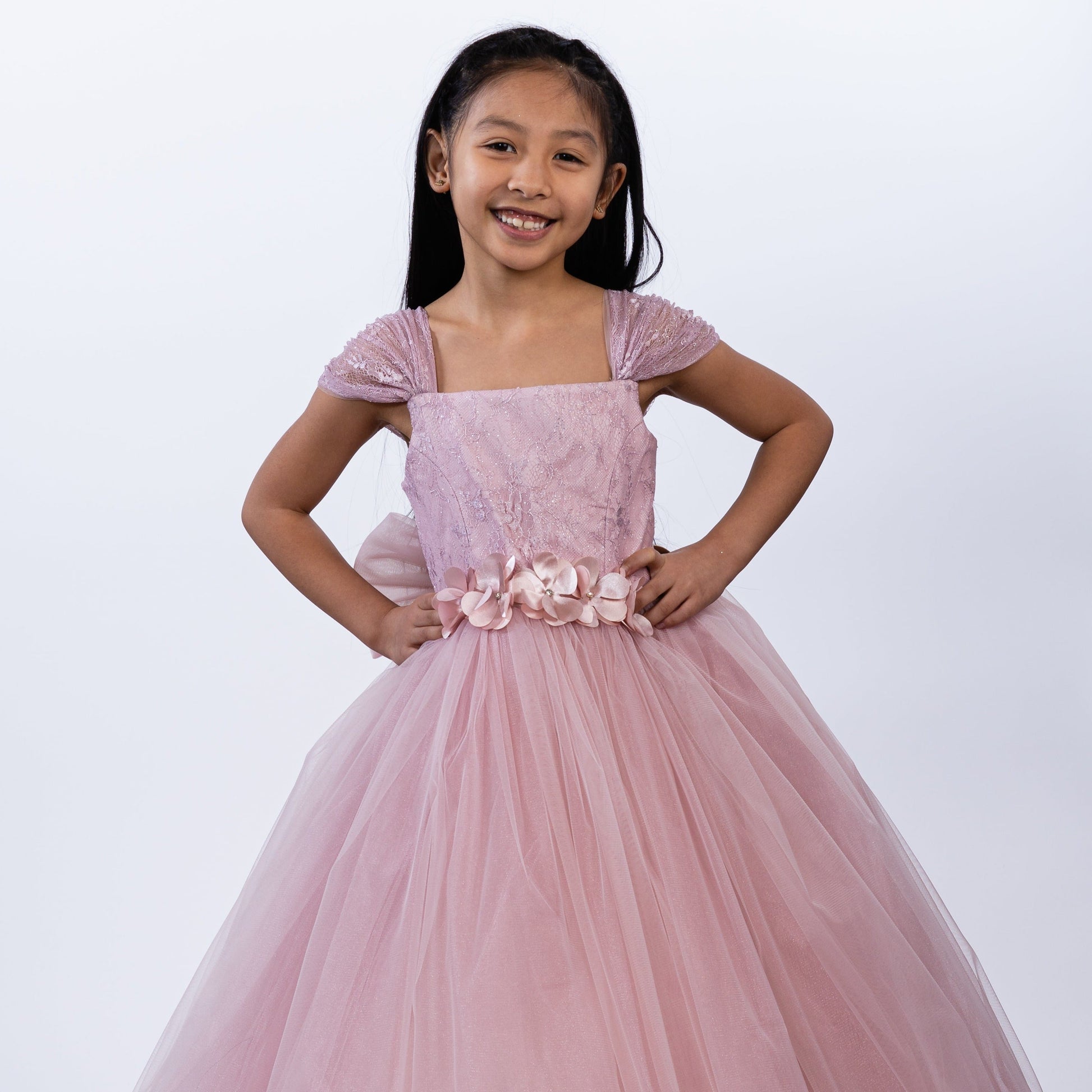 The Loveable Princess Girls Formal Dress features a pink tulle skirt, embellished bodice, and floral belt, perfect for specia