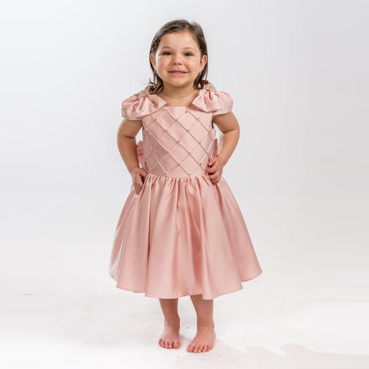 Girls formal dress in soft pink satin with puff sleeves and a quilted bodice, perfect for special occasions.