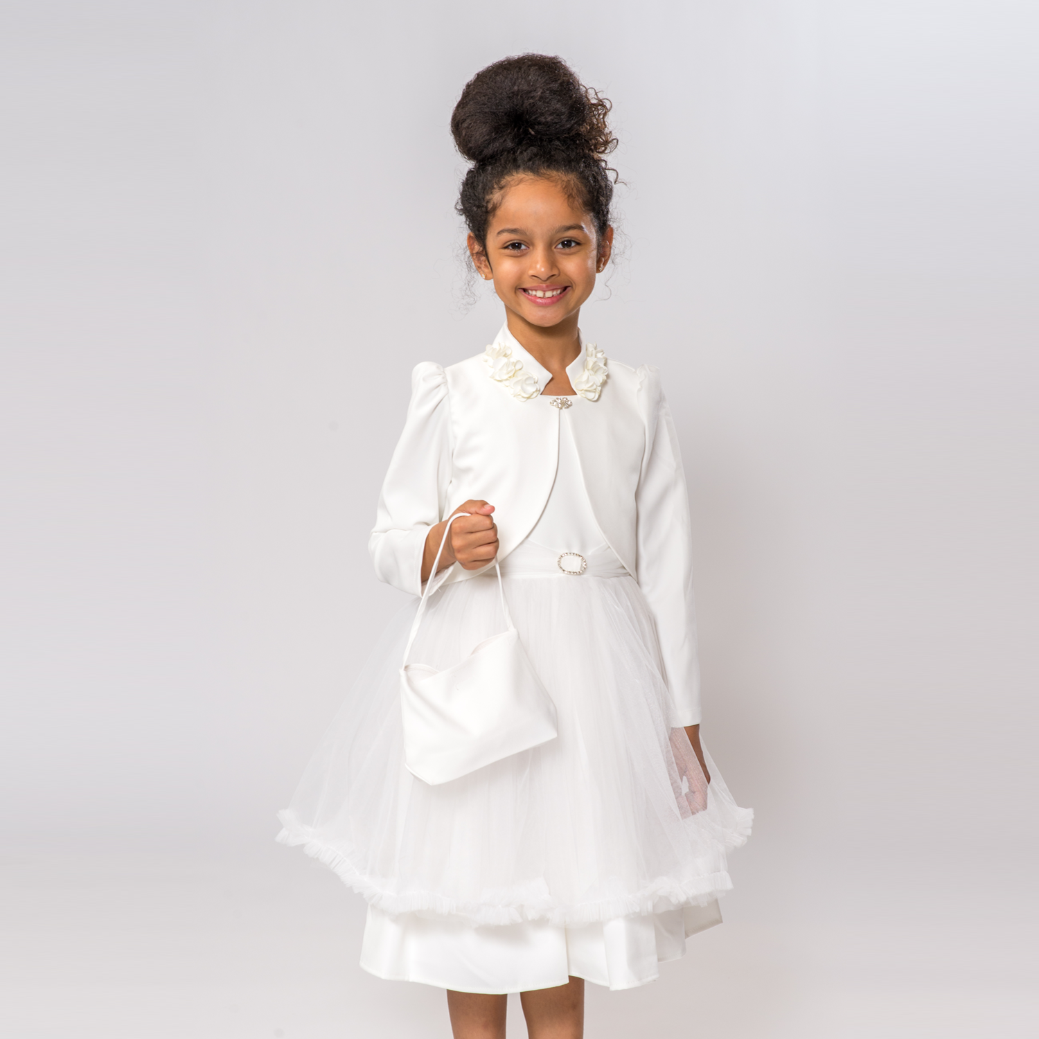 Claudia's Fancy Girl Dress features a white dress with a tulle overlay and a matching jacket, accessorized with a small handb
