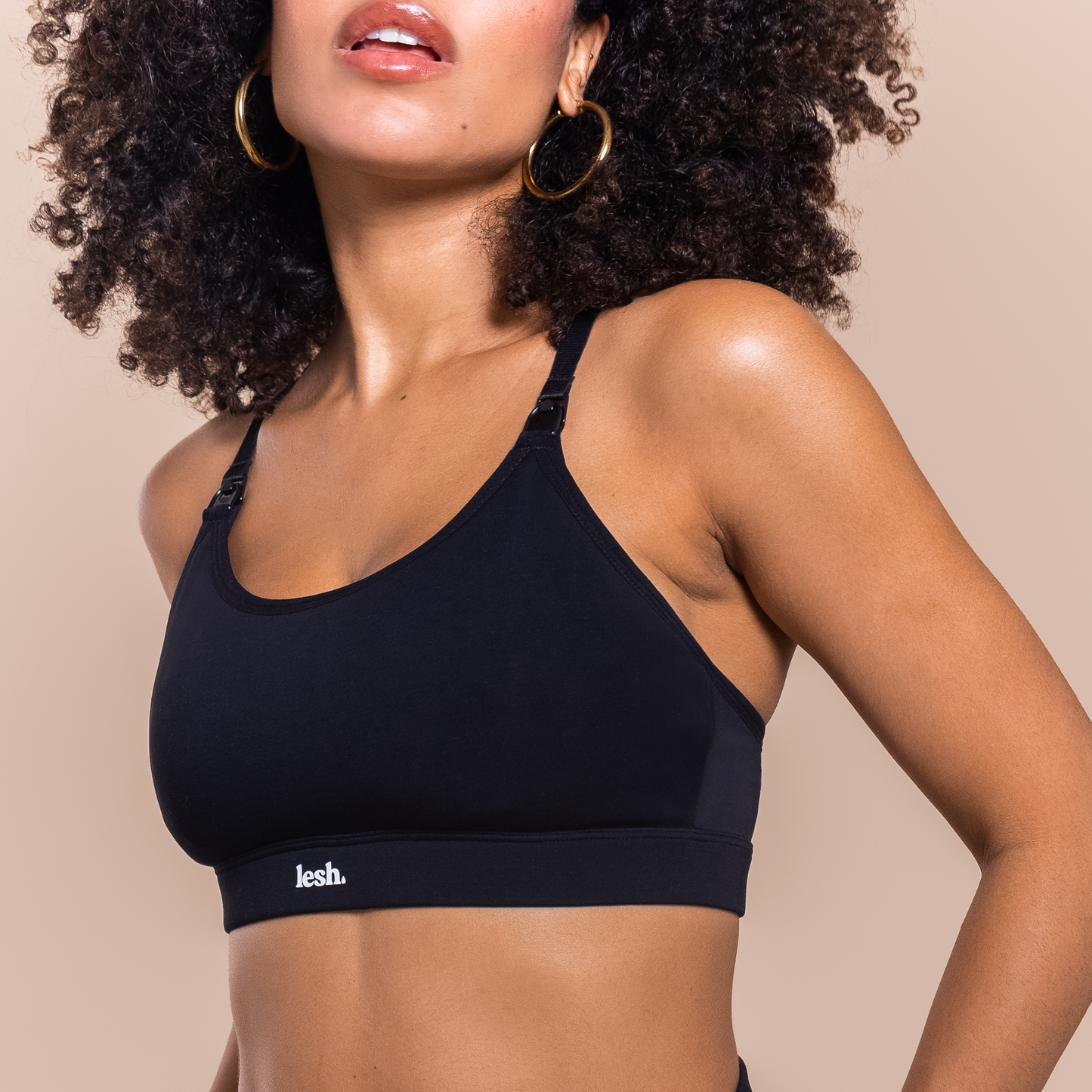 Black LESH FREEFLO 2.0 leakproof nursing bra displayed on a model, featuring adjustable straps and a comfortable fit.
