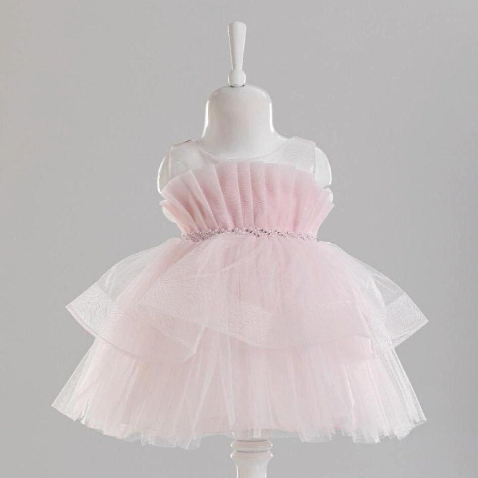 Blossom Baby Girls Formal Dress in soft pink with layered tulle skirt and a decorative waistband. Perfect for special occasio
