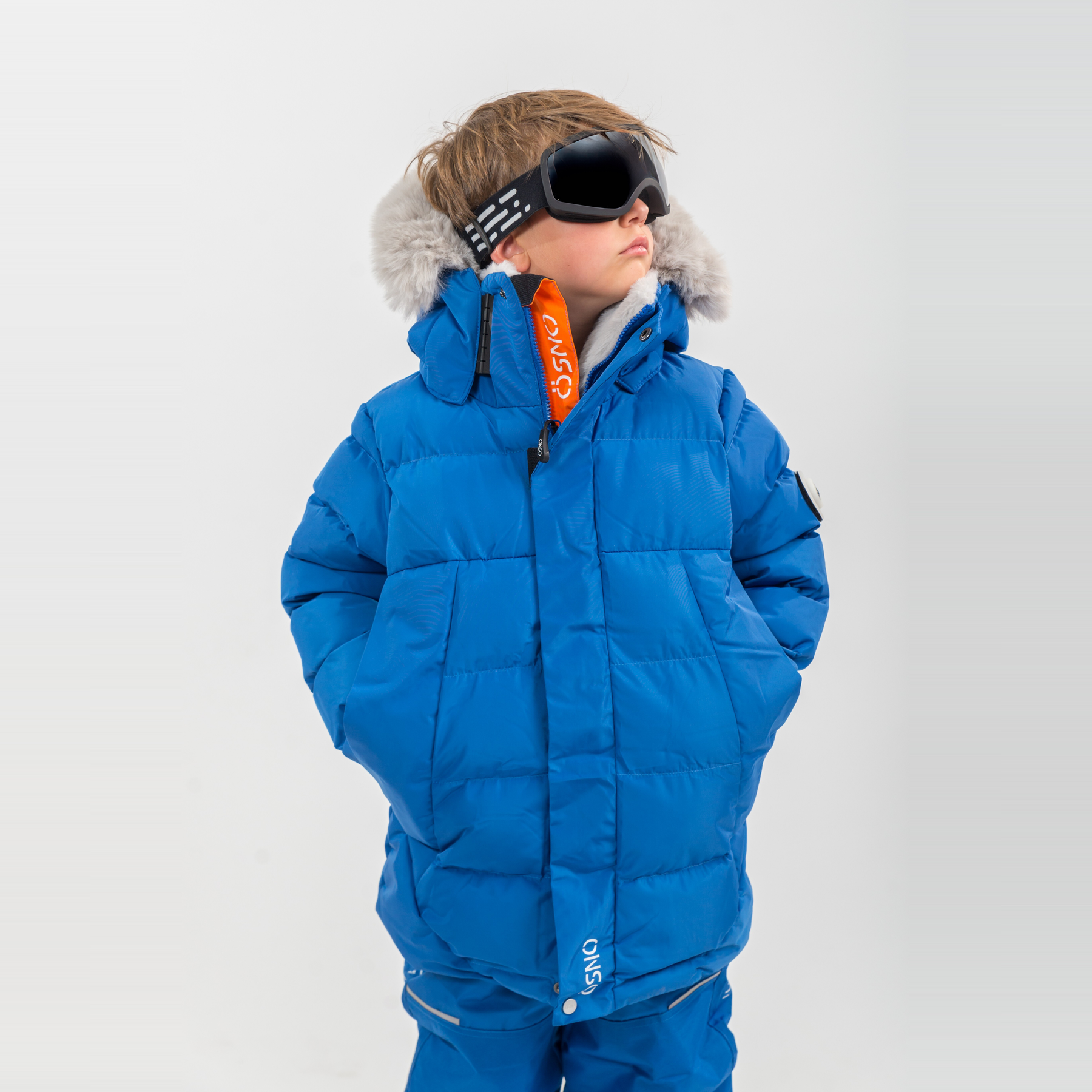 Liam's Luxury Snowsuit features a bright blue jacket with fur-lined hood and matching snowpants, perfect for winter activitie