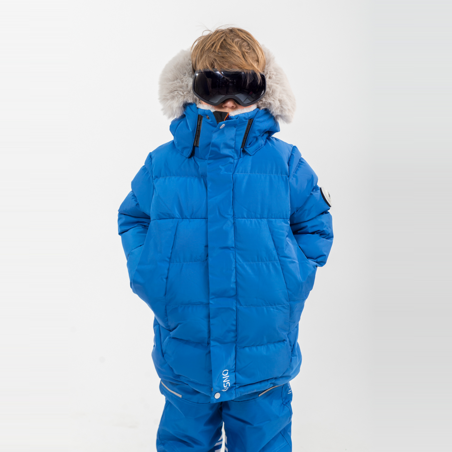 Liam's Luxury Snowsuit features a bright blue padded jacket with a fur-lined hood and matching snowpants, ideal for winter ac
