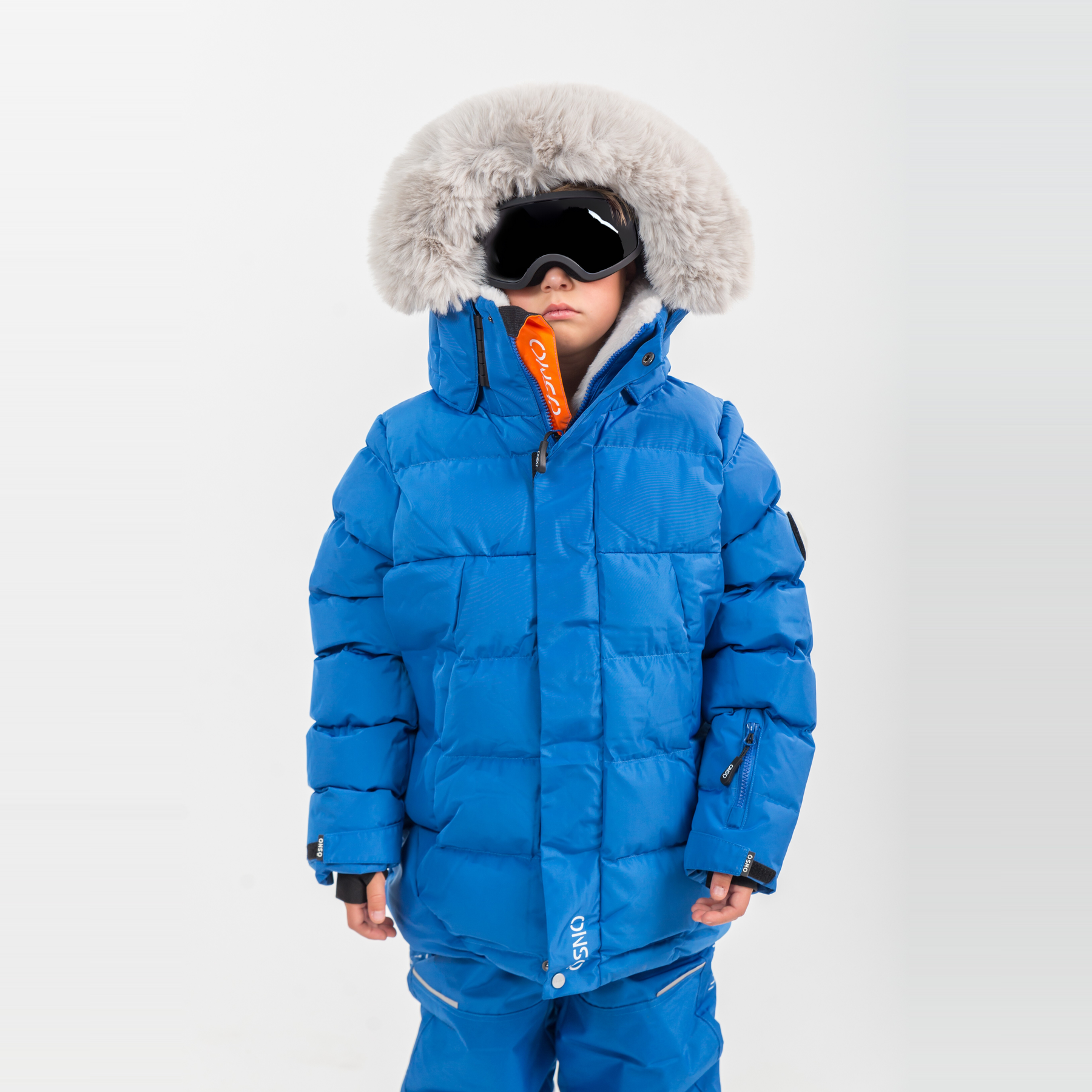 Liam's Luxury Snowsuit features a bright blue jacket with a fur-lined hood and matching snowpants, ideal for winter activitie