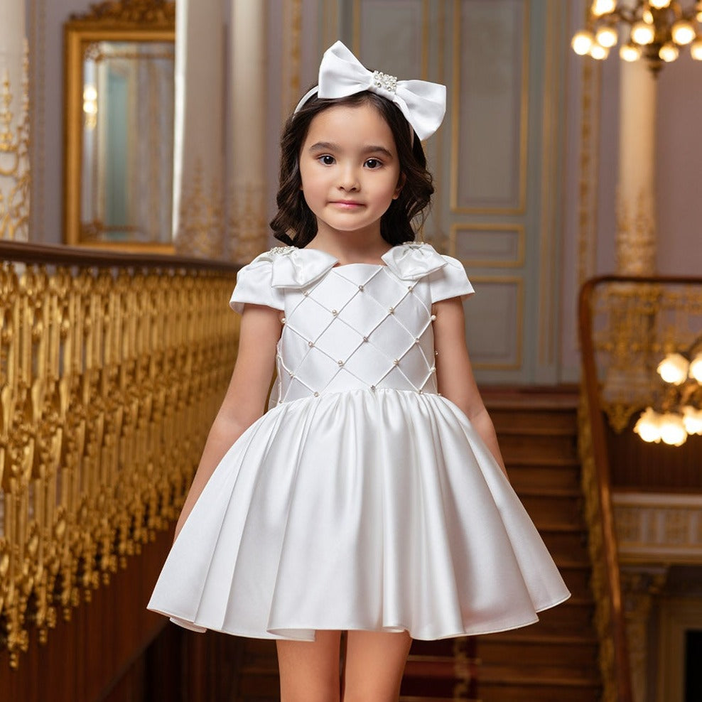 White formal dress for girls featuring short sleeves, a fitted bodice with pearl accents, and a flared skirt. Includes a matc