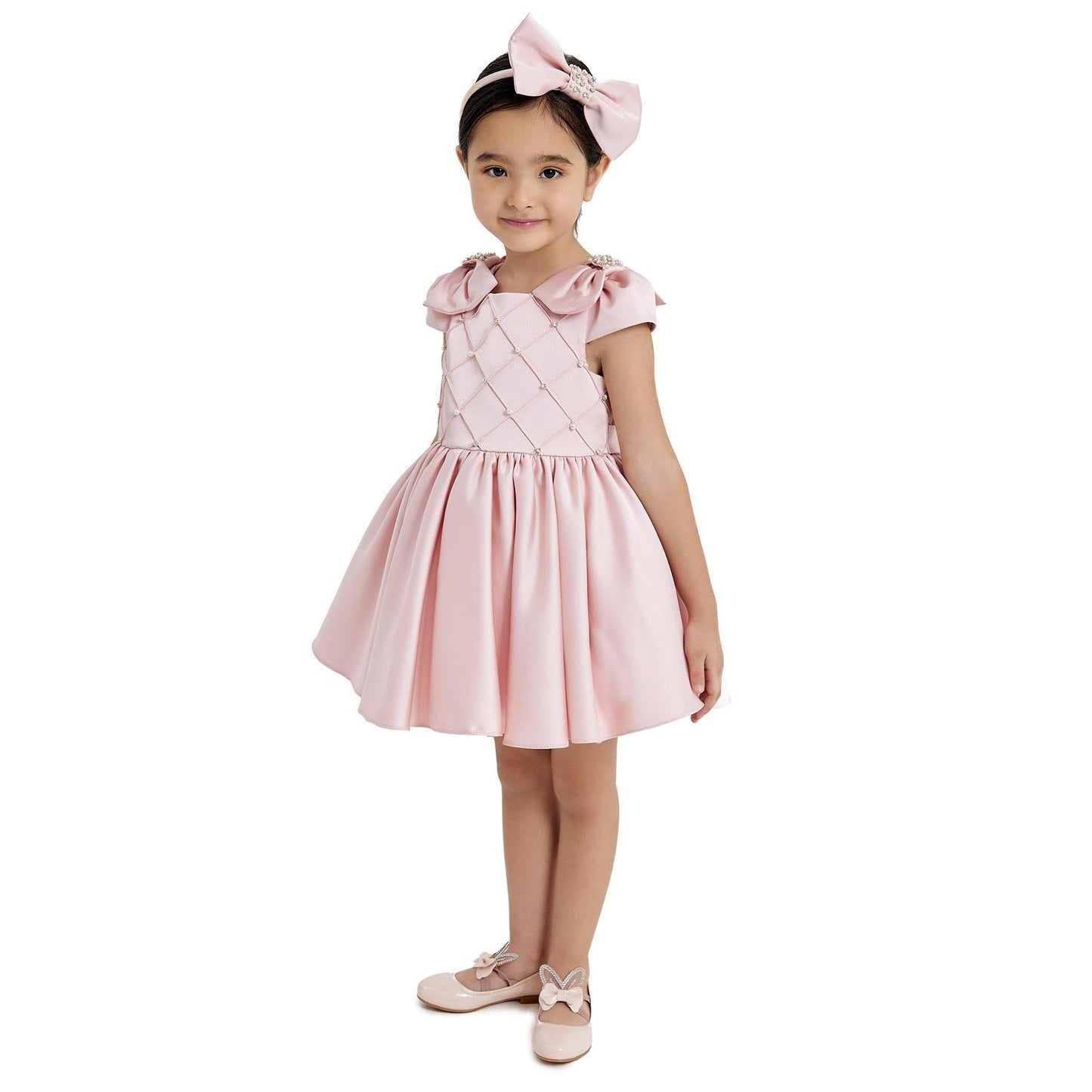 Pink Lady of Norway Girls Formal Dress with puff sleeves, a quilted bodice, and a flared skirt, paired with a matching bow he