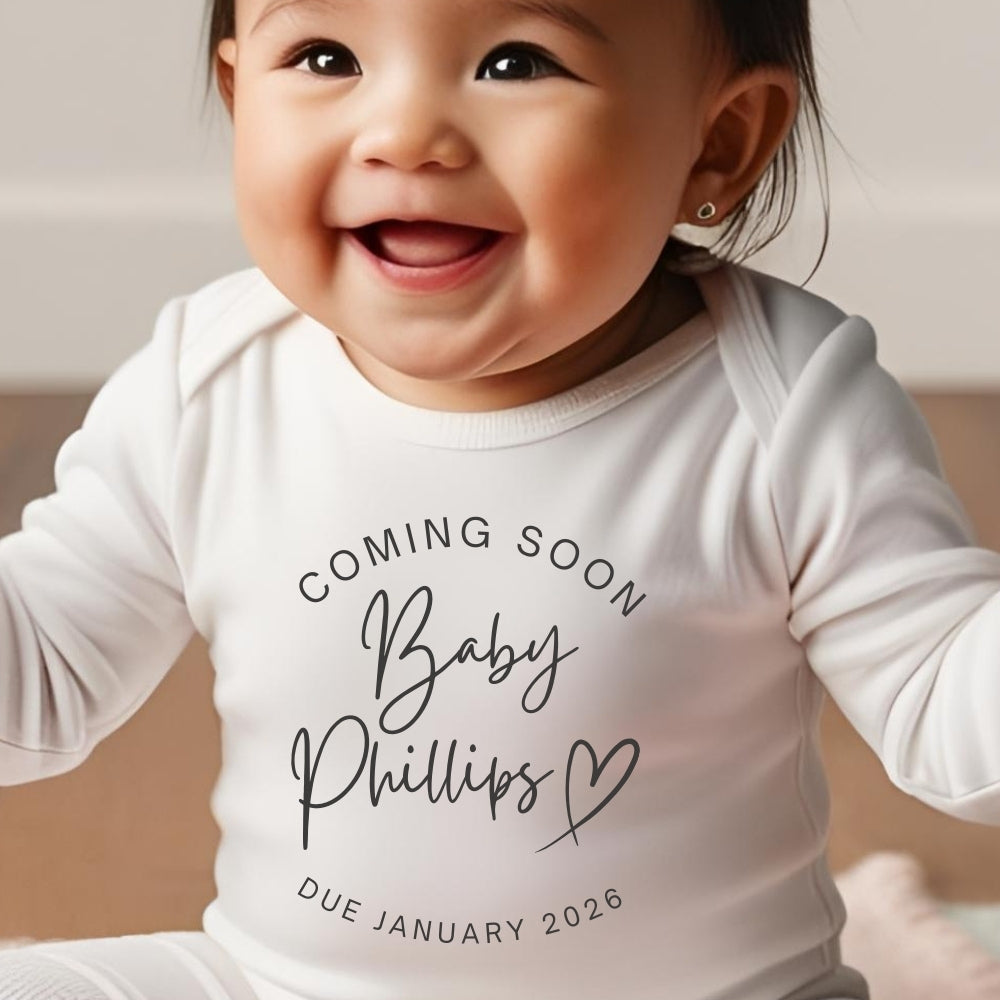 Personalised Coming Soon Baby Outfit featuring a smiling baby in a white vest with custom text for a due date.