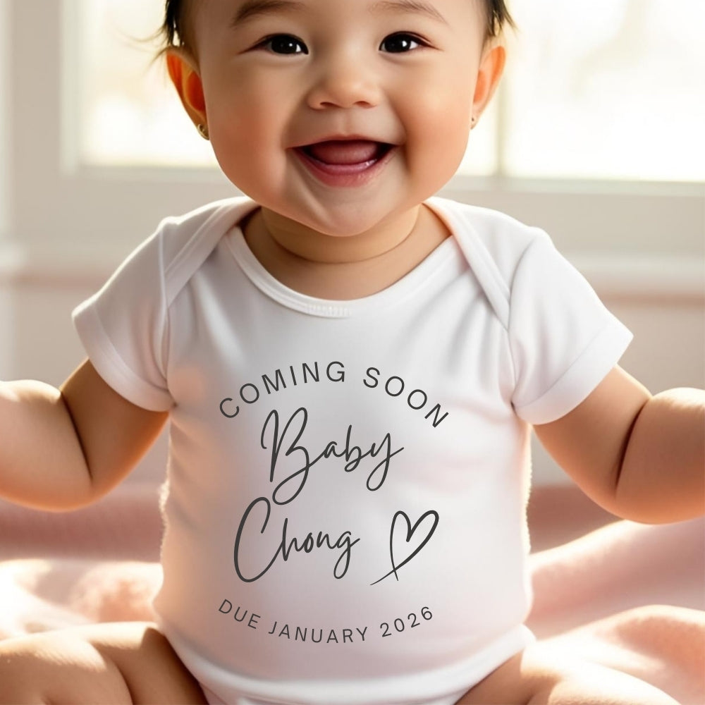 Personalised Coming Soon Baby Outfit featuring a smiling baby in a white onesie with "Coming Soon Baby Chong" text.