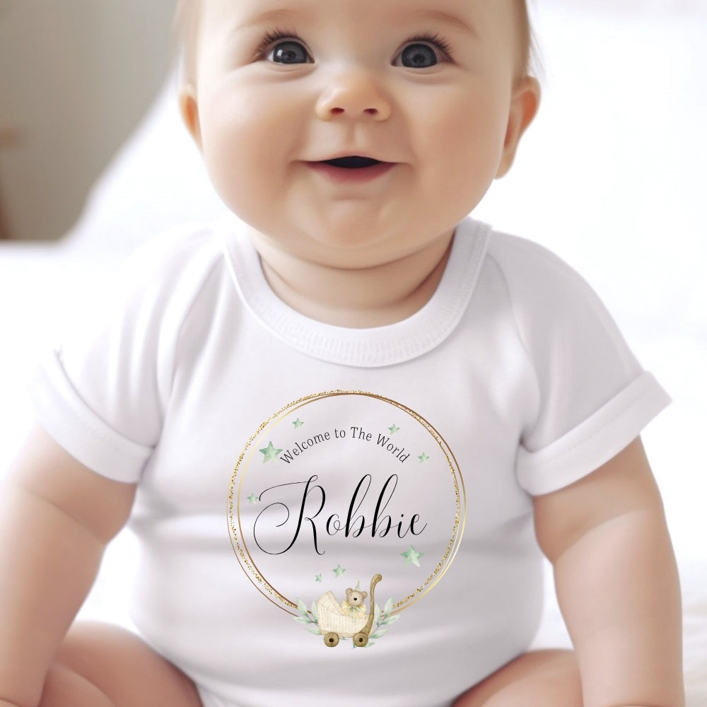 Personalised Welcome to the World Baby Outfit featuring a smiling baby in a white vest with "Welcome to The World Robbie" des