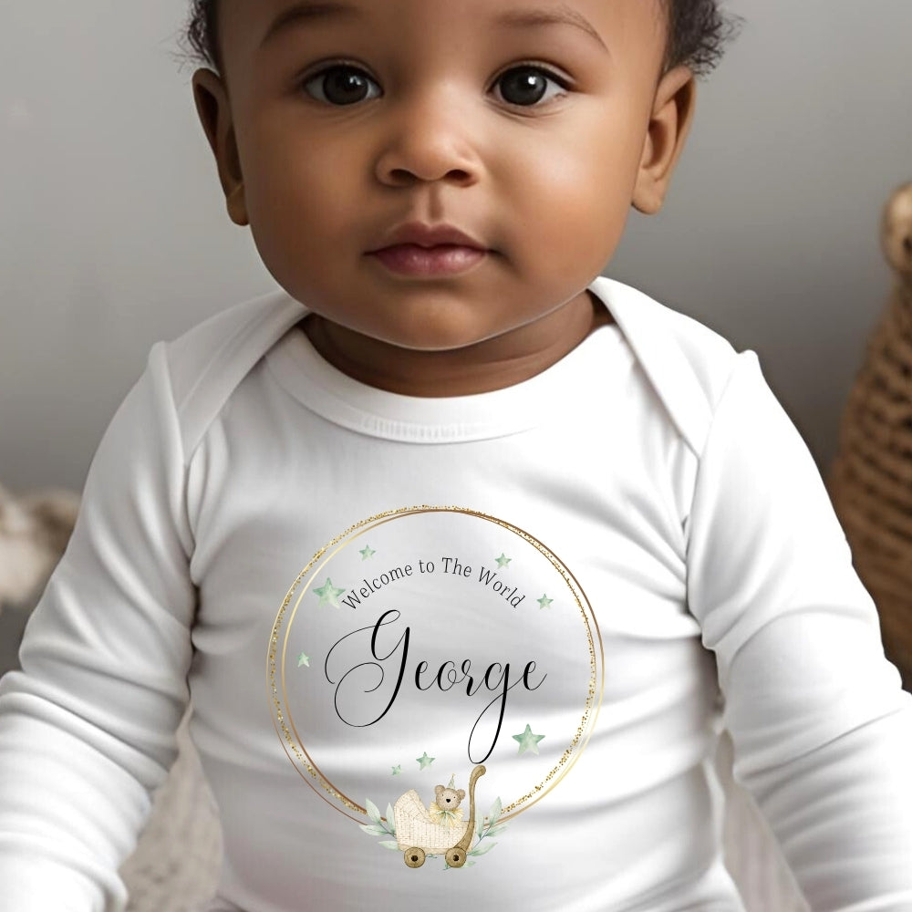 Personalised Welcome to the World Baby Outfit featuring a white vest with "Welcome to The World George" design.