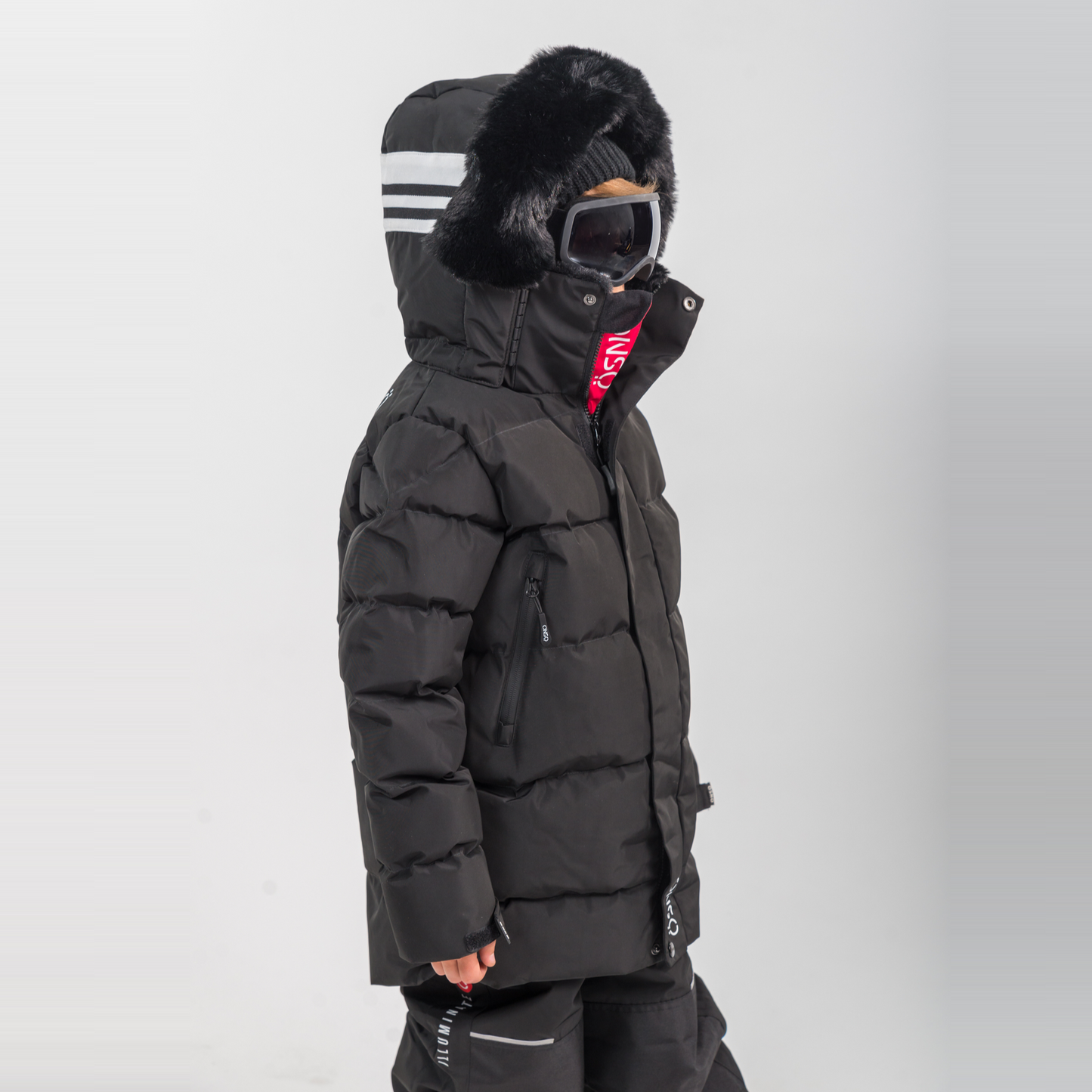 Rafa's Luxury Snowsuit featuring a black puffy jacket with fur-lined hood and matching snowpants, designed for winter wear.