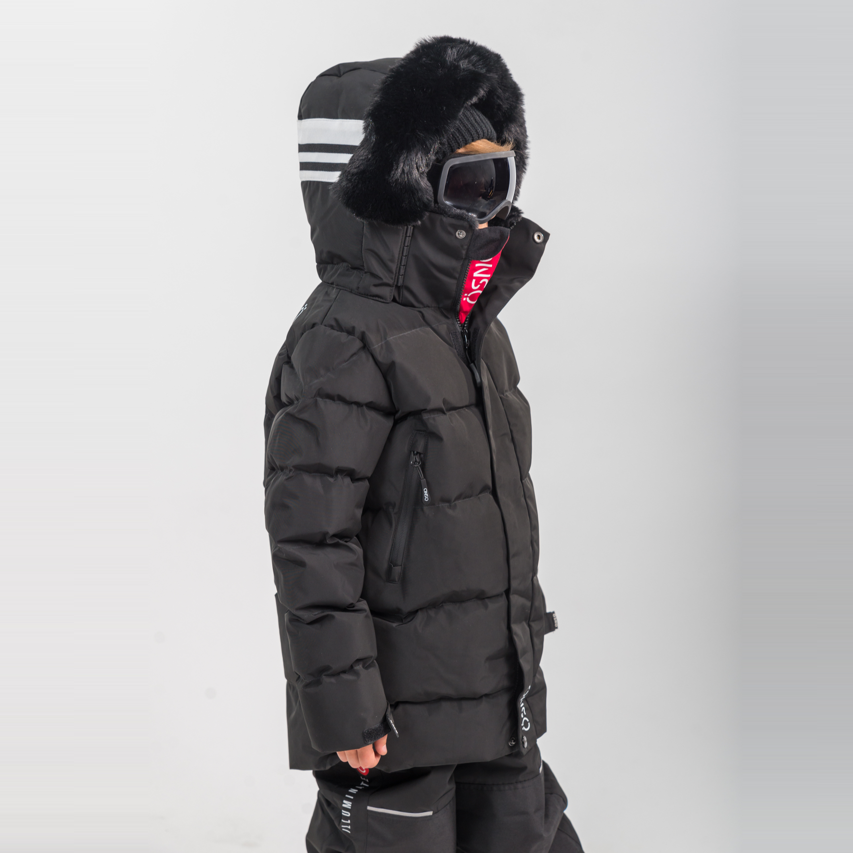 Rafa's Luxury Snowsuit featuring a black puffy jacket with fur-lined hood and matching snowpants, designed for winter wear.