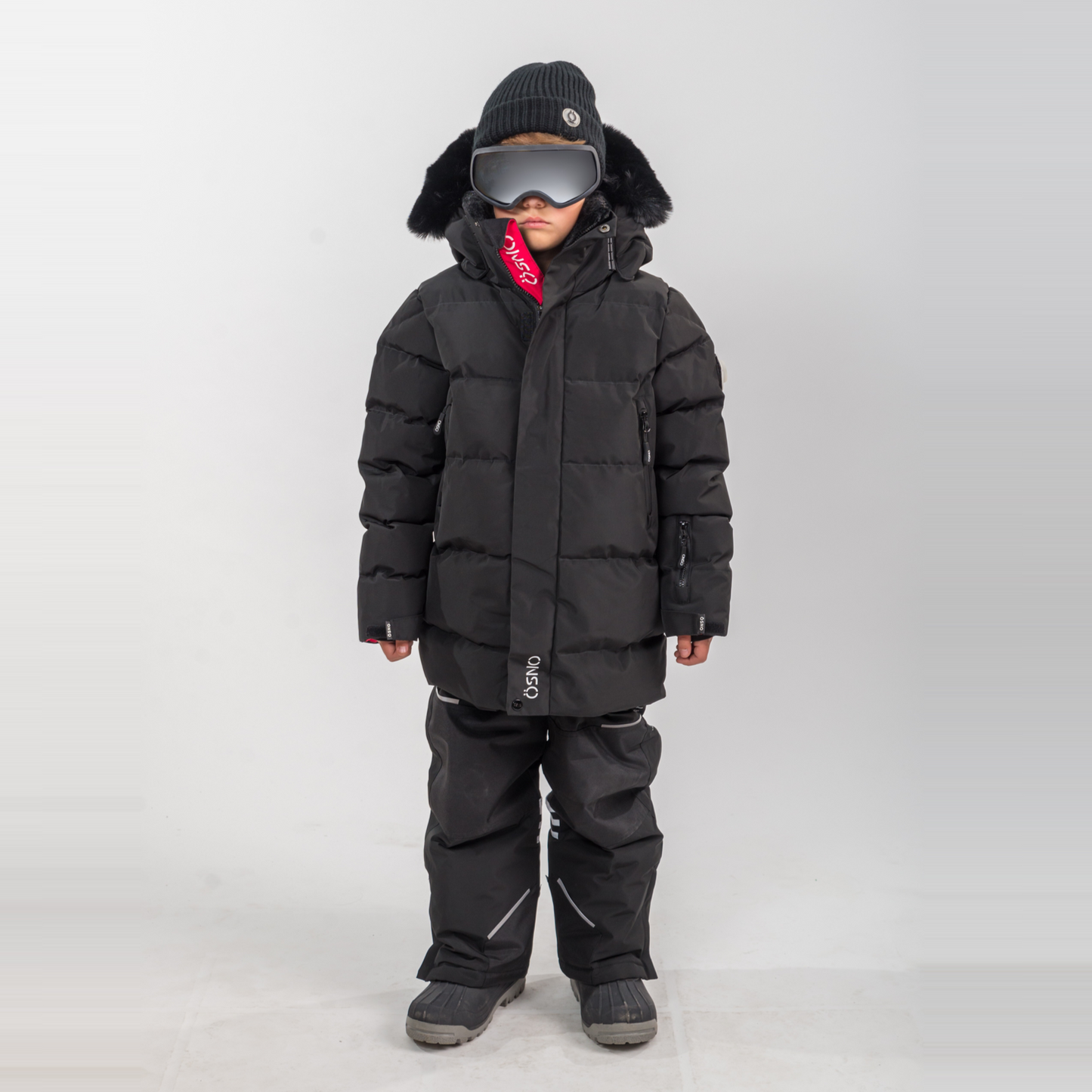 Rafa's Luxury Snowsuit features a black puffer jacket and matching snowpants, designed for kids with a stylish winter look.