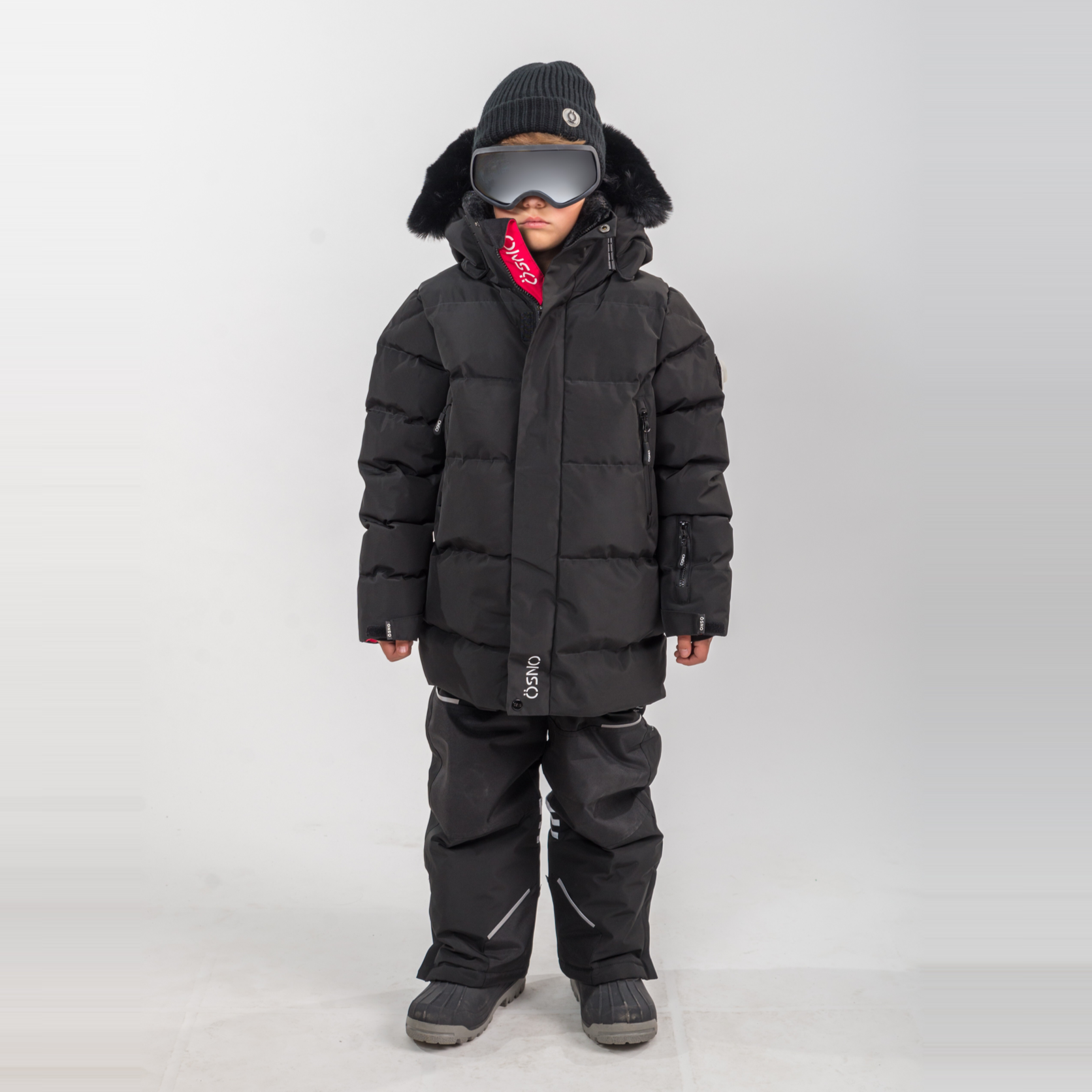 Rafa's Luxury Snowsuit features a black puffer jacket and matching snowpants, designed for kids with a stylish winter look.