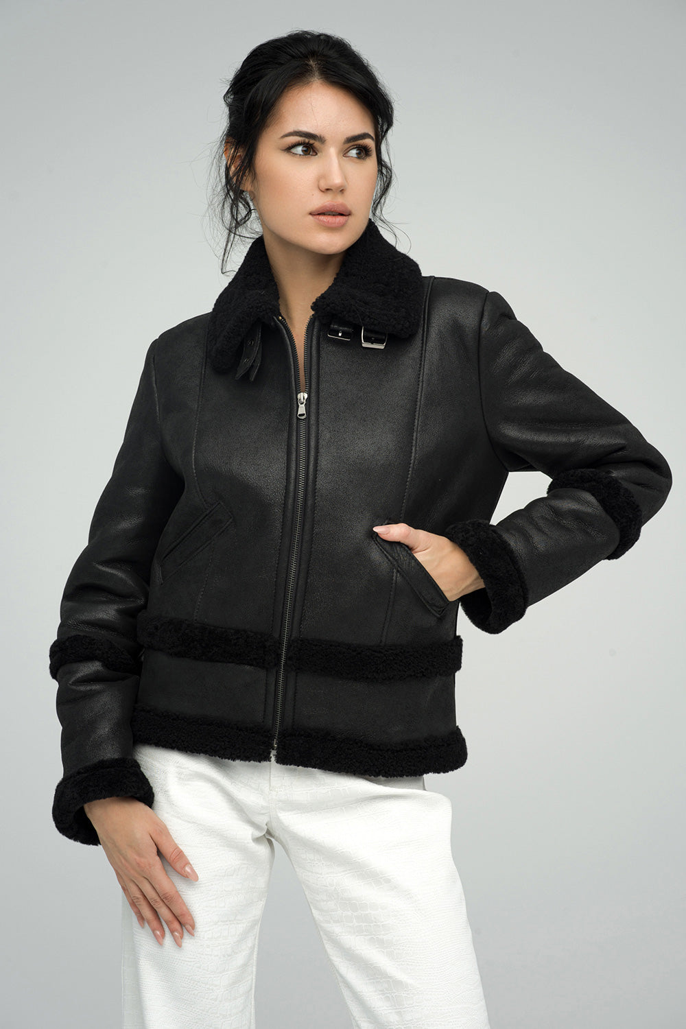 Black Merino Shearling Leather Jacket featuring a zip front, plush collar, and shearling trim on cuffs and hem.
