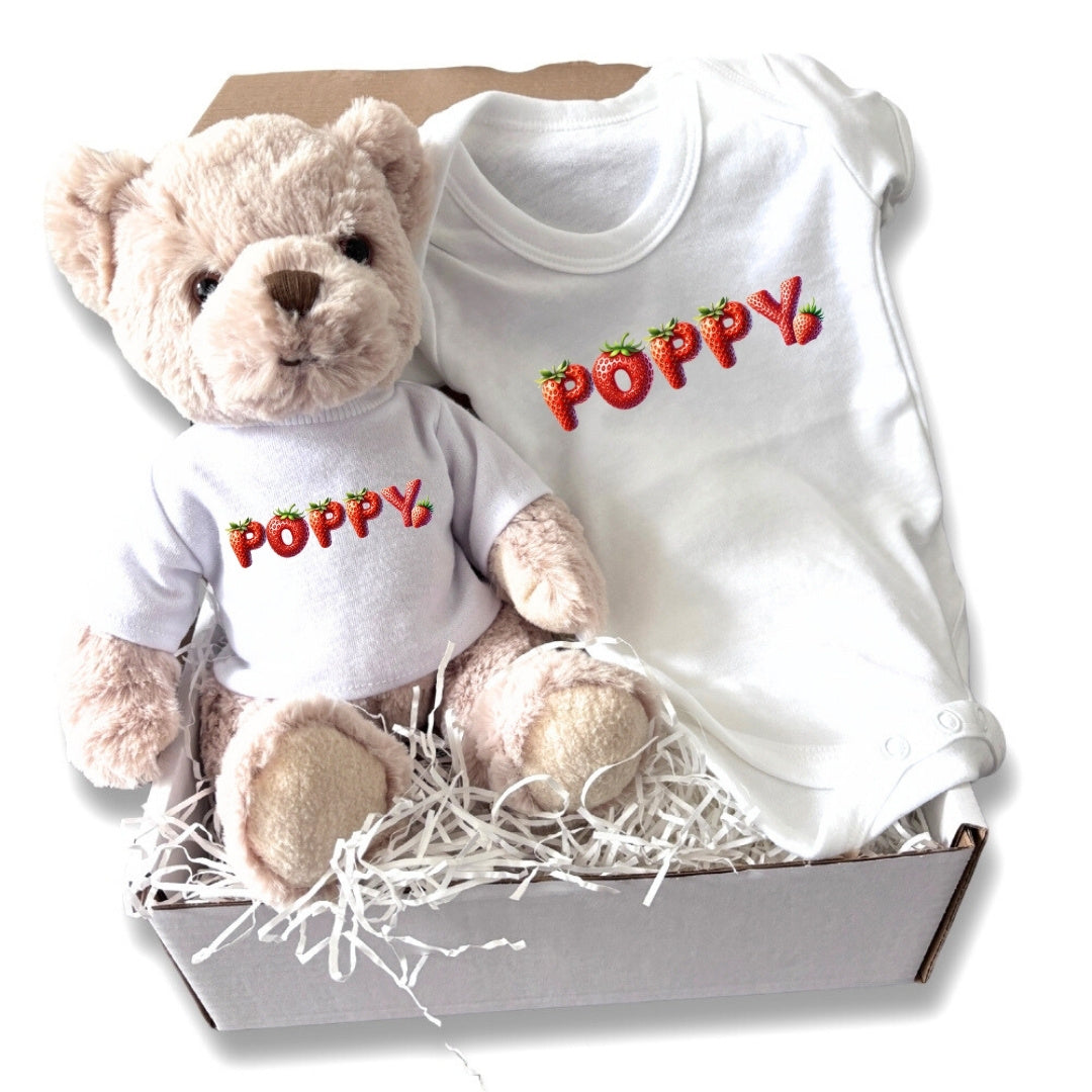 Personalised Strawberry Name Baby Gift Hamper featuring a teddy bear and a baby vest with the name "Poppy" embroidered.