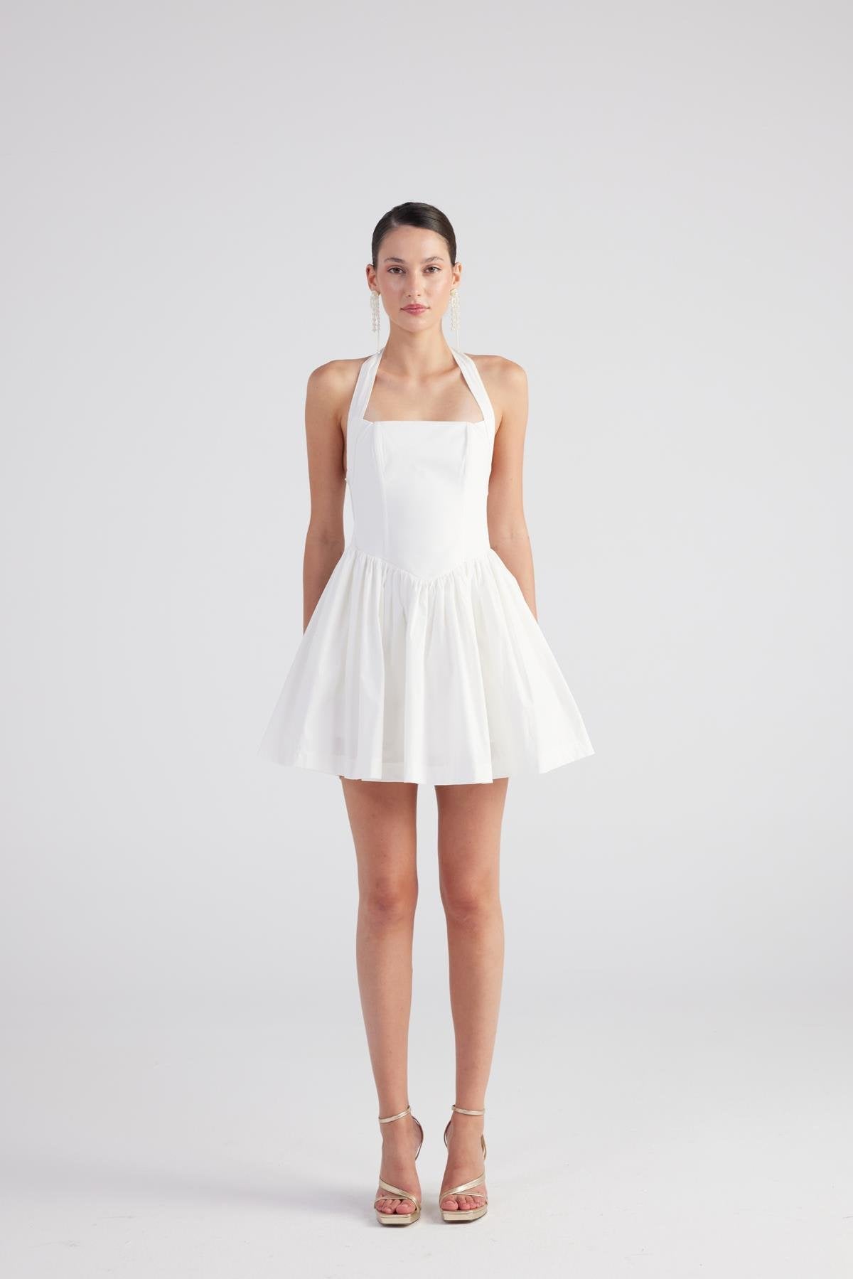 Teresa White Pleated Skirt Mini Dress featuring a square neckline and halter straps, with a flared pleated skirt.