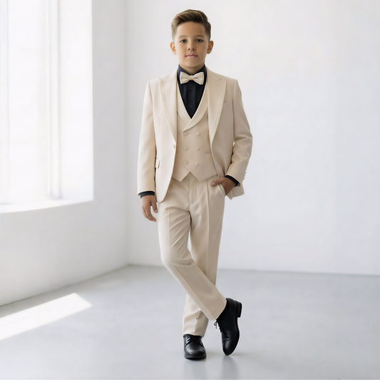 Boys' tuxedo in cream with black bow tie, featuring a double-breasted vest and tailored pants, styled for formal occasions.