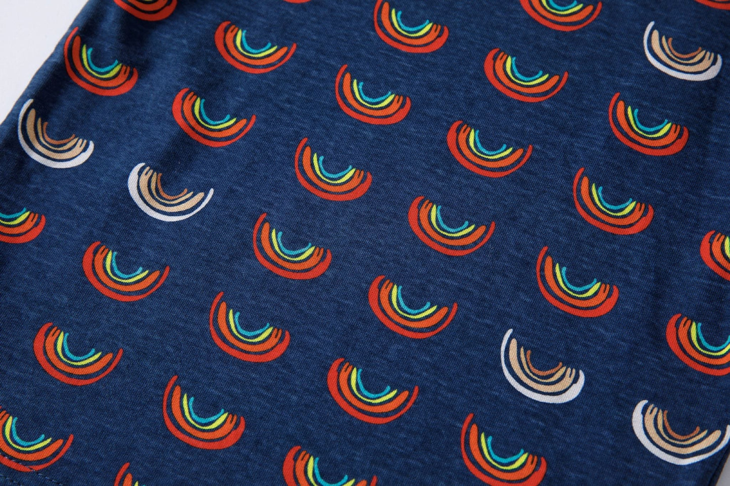 Boob Over the Rainbow Kids top featuring a navy fabric with colorful rainbow patterns in red, green, and beige.